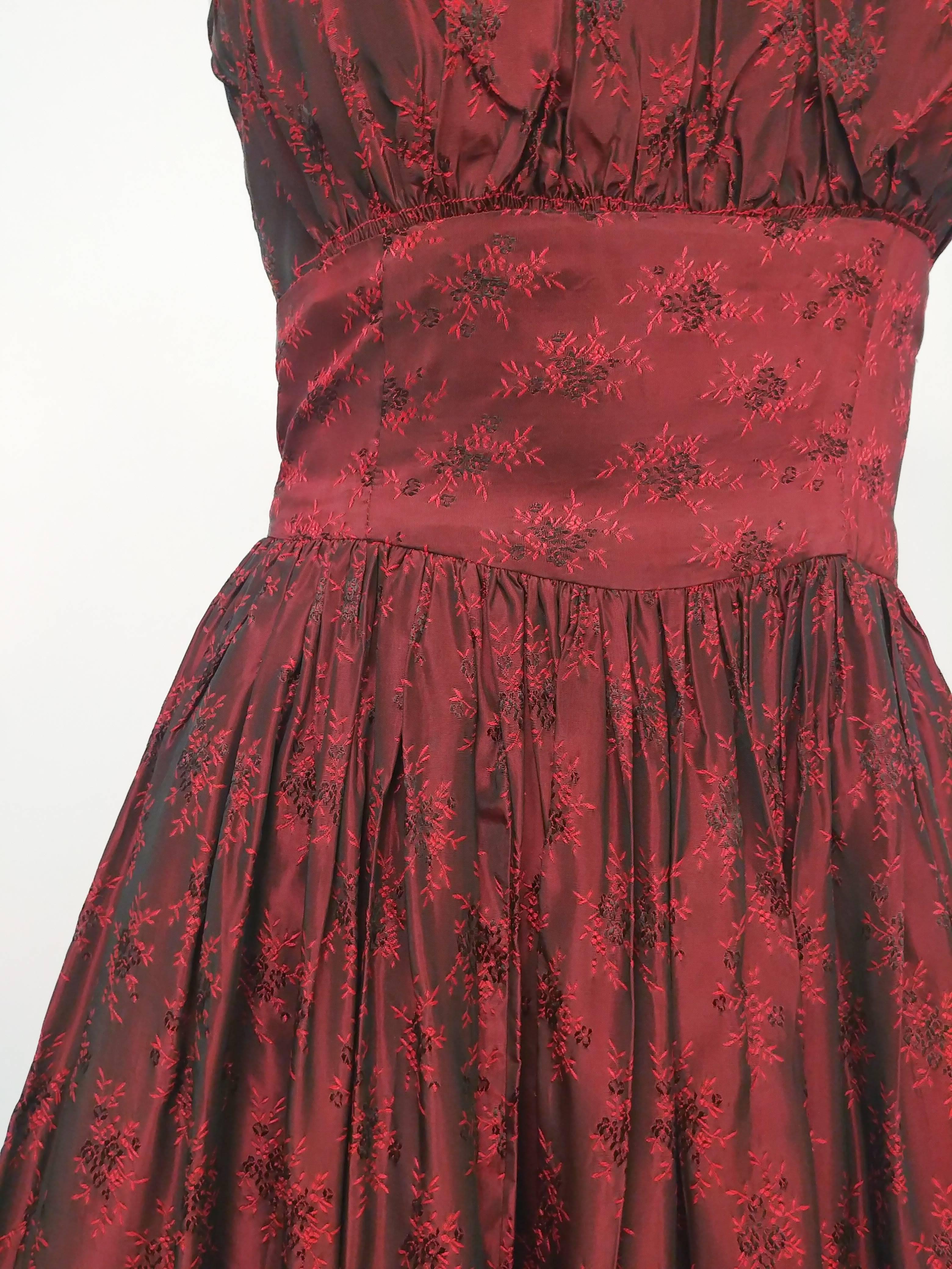 1950s Red Iridescent Party Dress. Black and red iridescent jacquard fabric, gathered skirt and bust. Zips up side. 