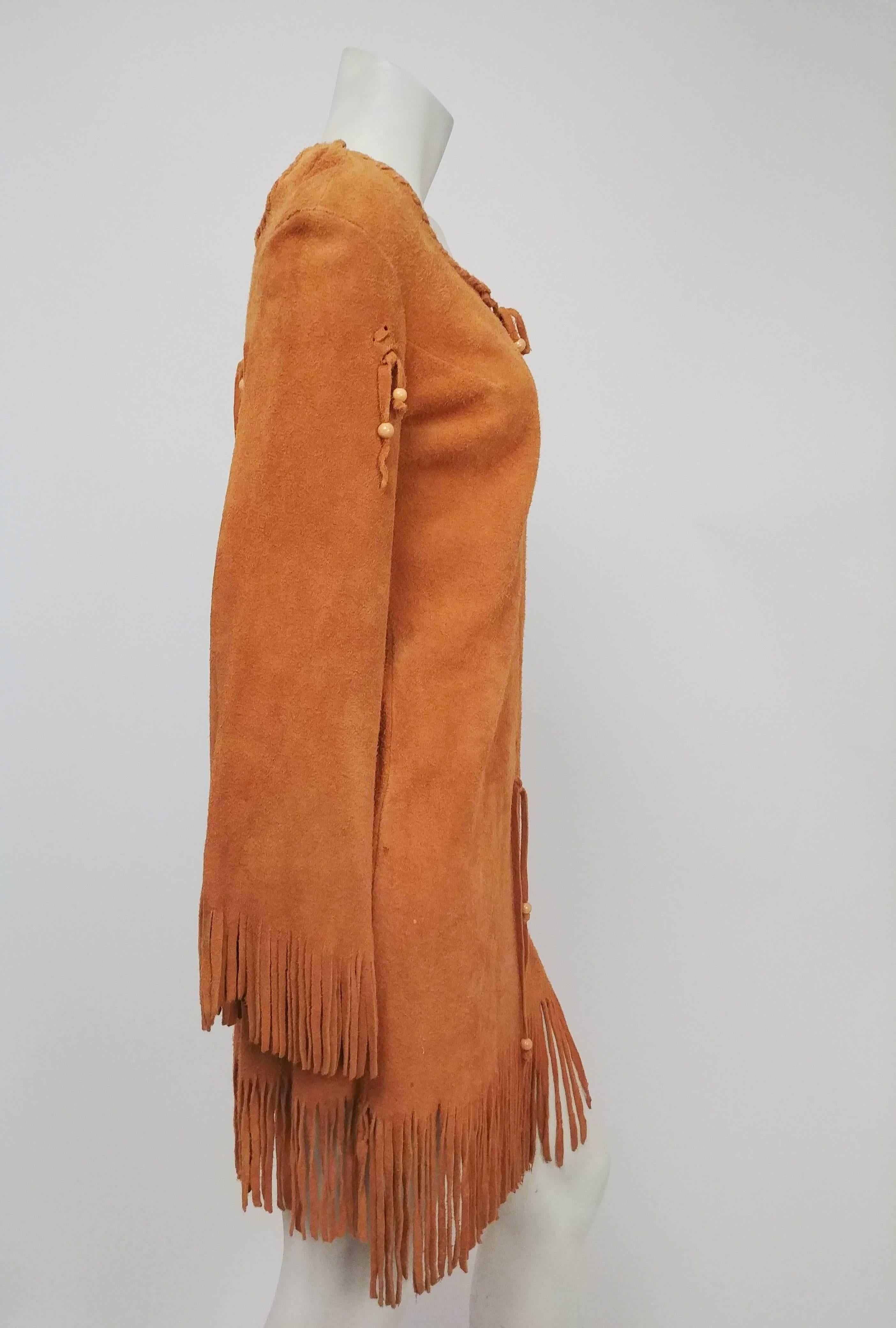 1960s Elk Suede Fringe Hippie Dress. Lace-up front and decorative fringe on back and hem. No closures. 