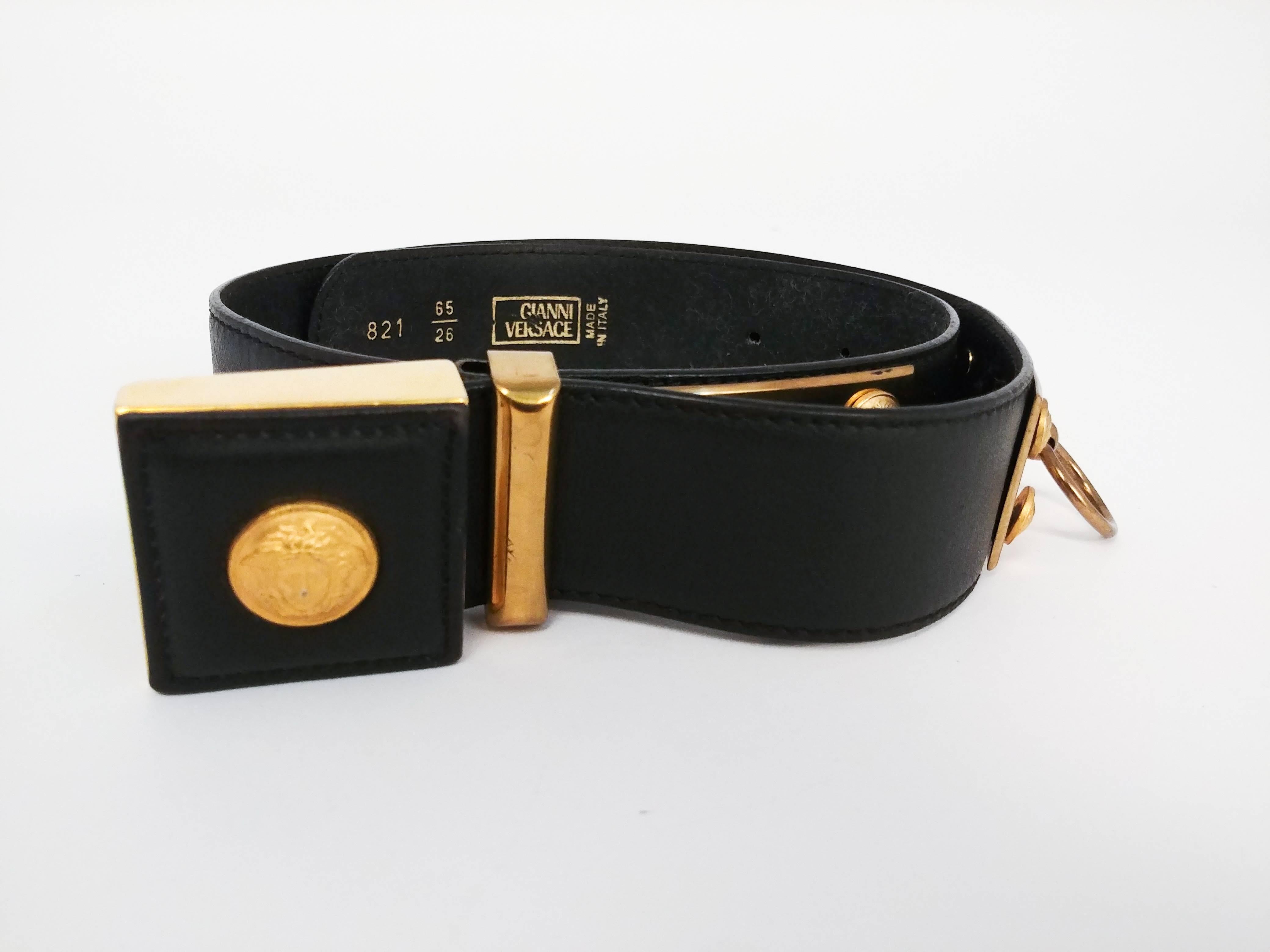 1980s Versace Leather Belt. Iconic logo belt buckle. O-ring details at sides. 