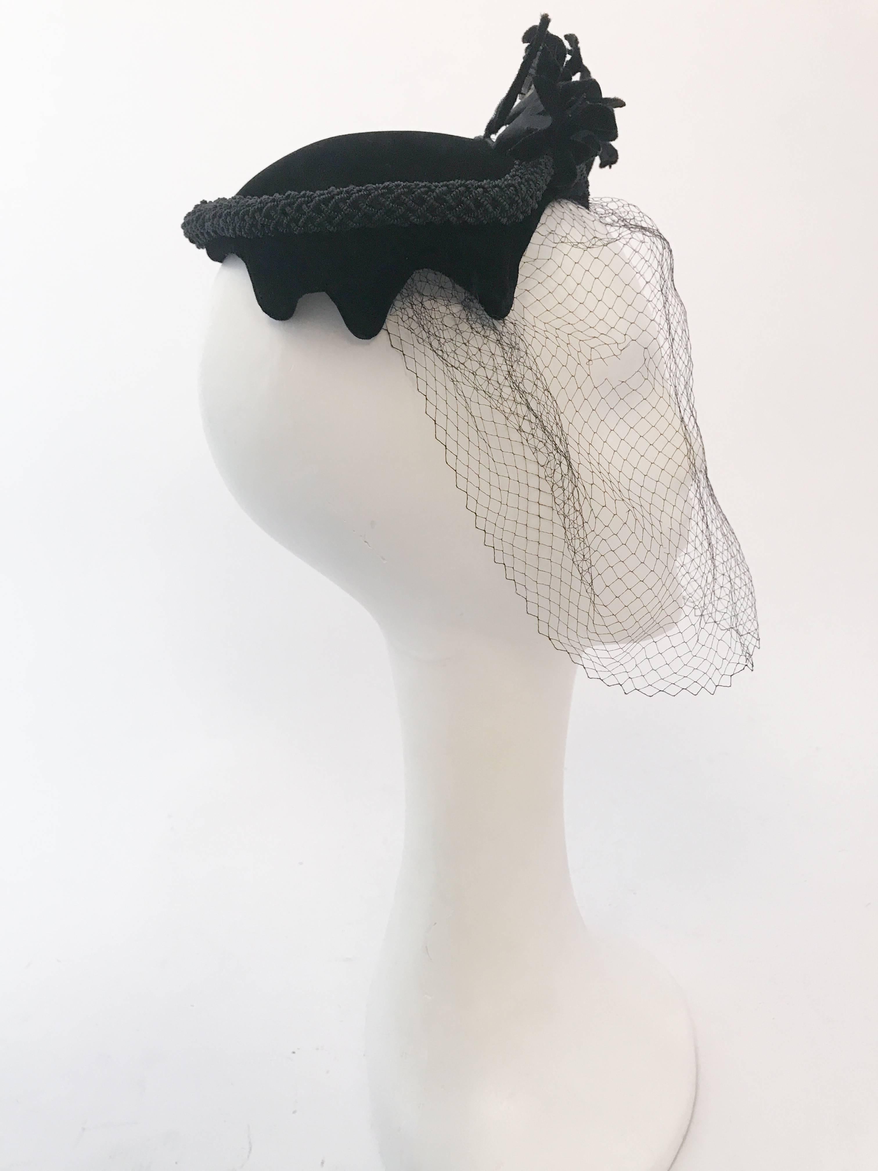 1950s Black Velvet Cocktail Hat with Veil and Flower Embellishments. Black velvet hat with matching veil, velvet flowers, and rhinestone embellishments.