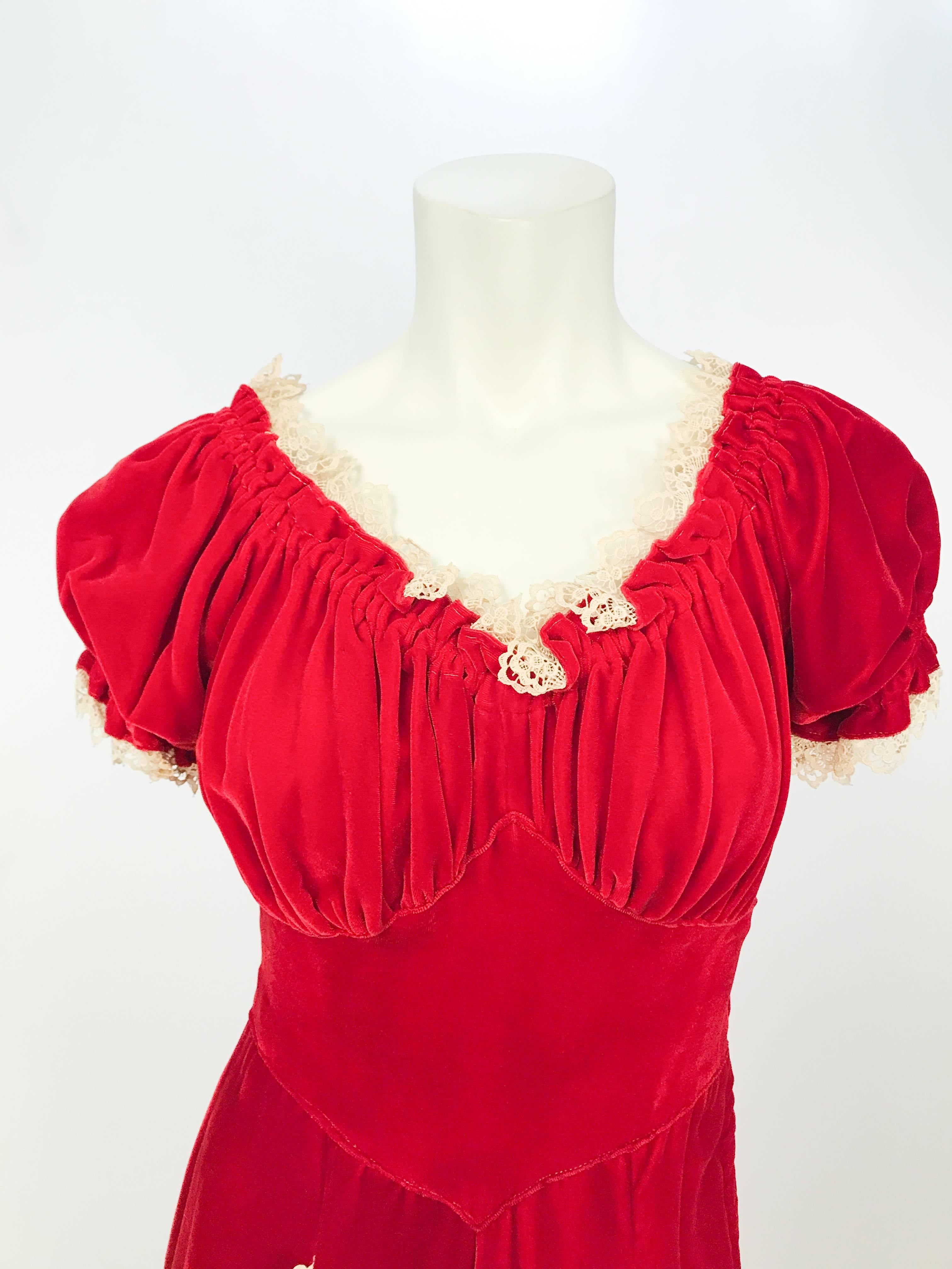 1930s Red Velvet and Lace Dress. Red velvet dress with machine lace sleeves, pockets, and neckline. Gathered around the bust and belted waist.