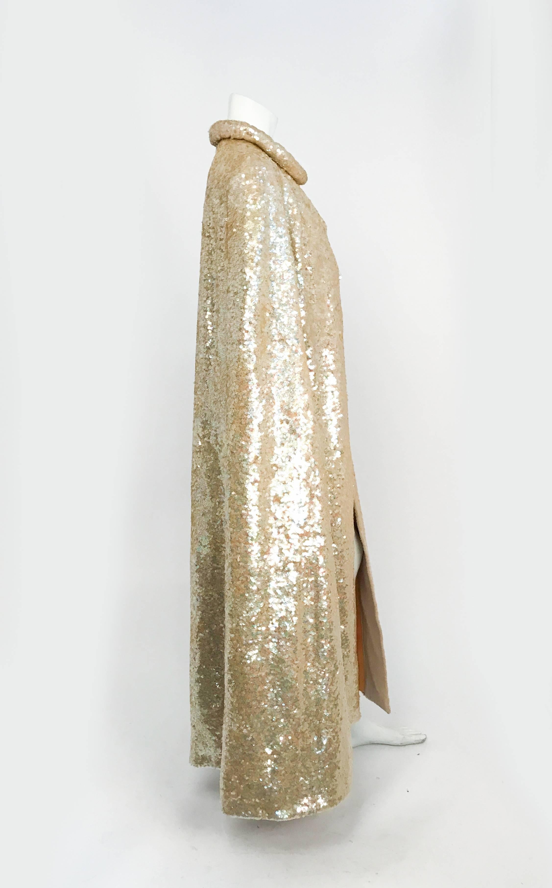 1960s Gold Sequin Cape. Gold sequin on knit roll cape with silk lining and slit sleeves.