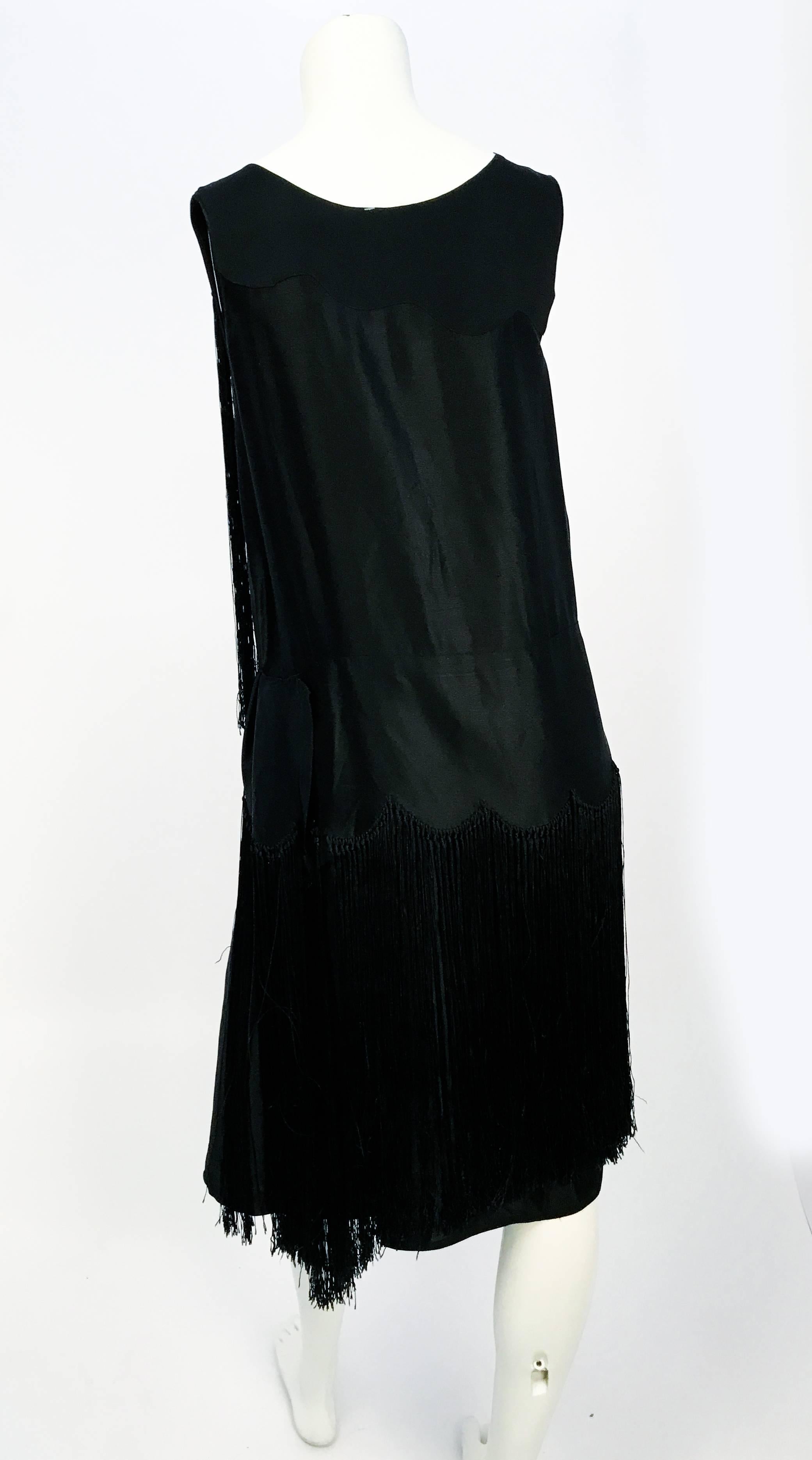 Vestido de noche de satén negro de los años 20. Con 2 filas de flecos extra largos de rayón en un diseño festoneado. 