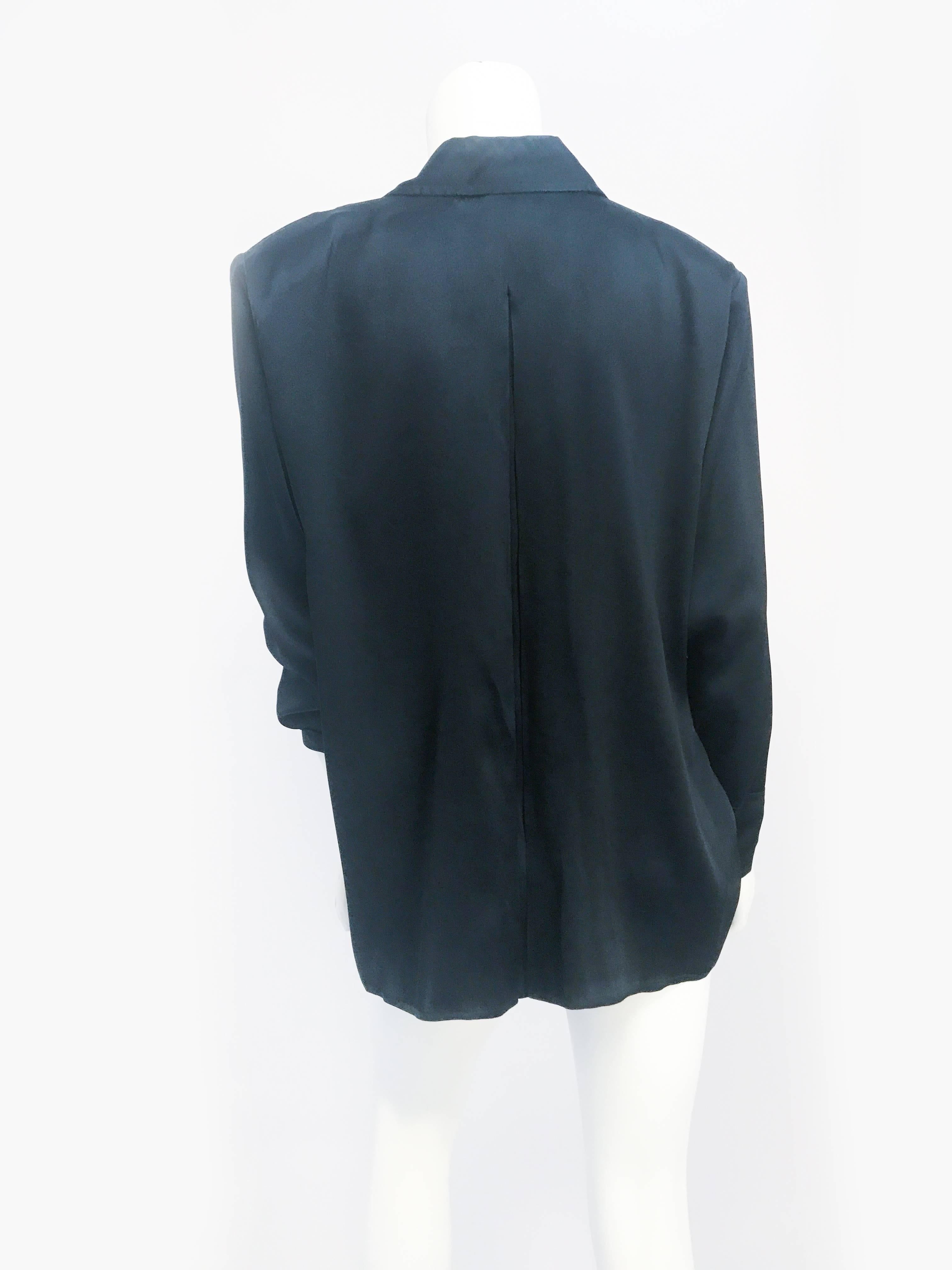 1980s Yves Saint Laurent Black Silk Blouse. Black silk blouse with padded shoulder and oversized pleats.