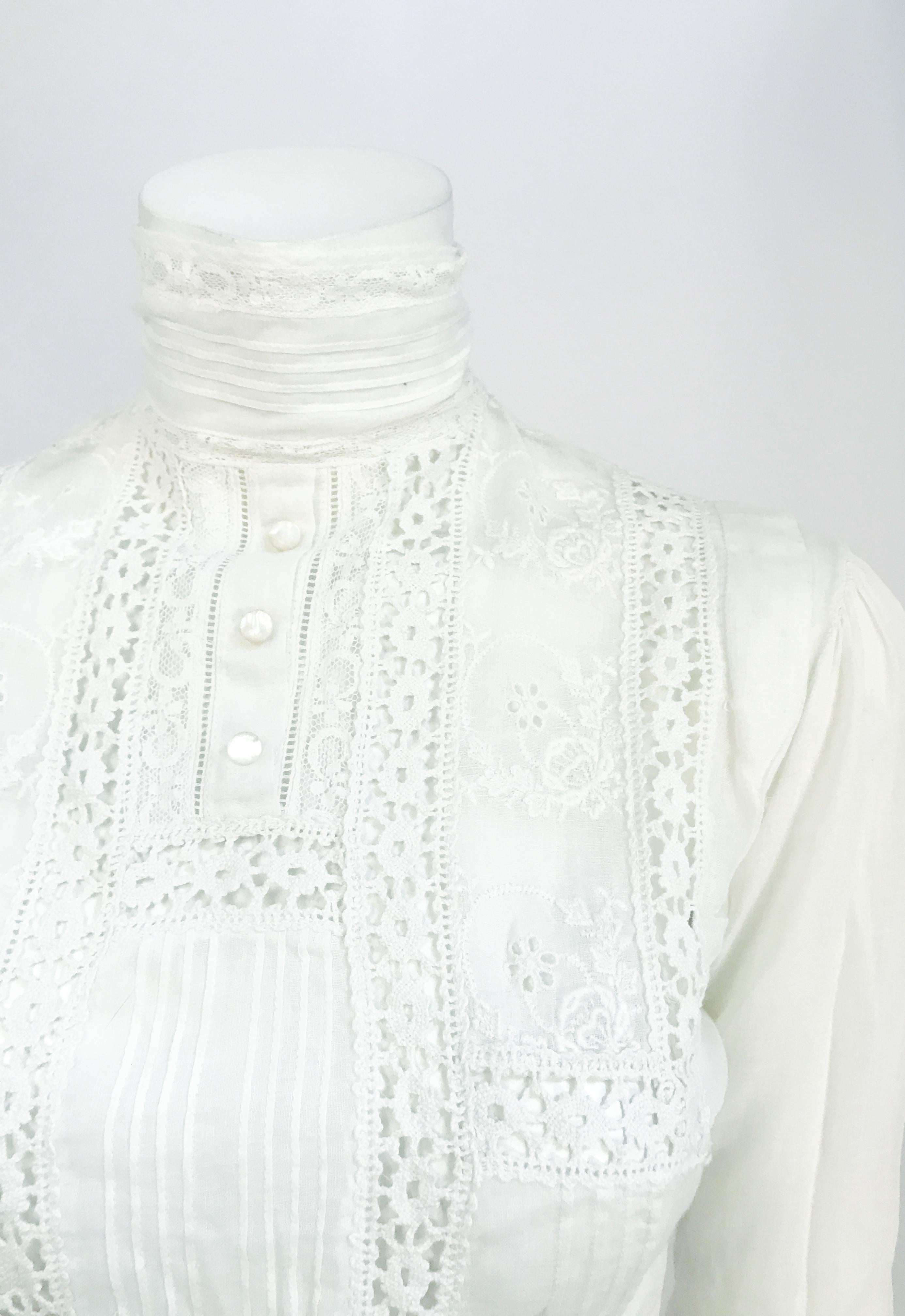 Edwardian White Cotton Long Sleeve Blouse. White cotton blouse with long sleeves, modified bidgeon chest, pleats, and lace trims. High-necked collar and shell buttons up the back 