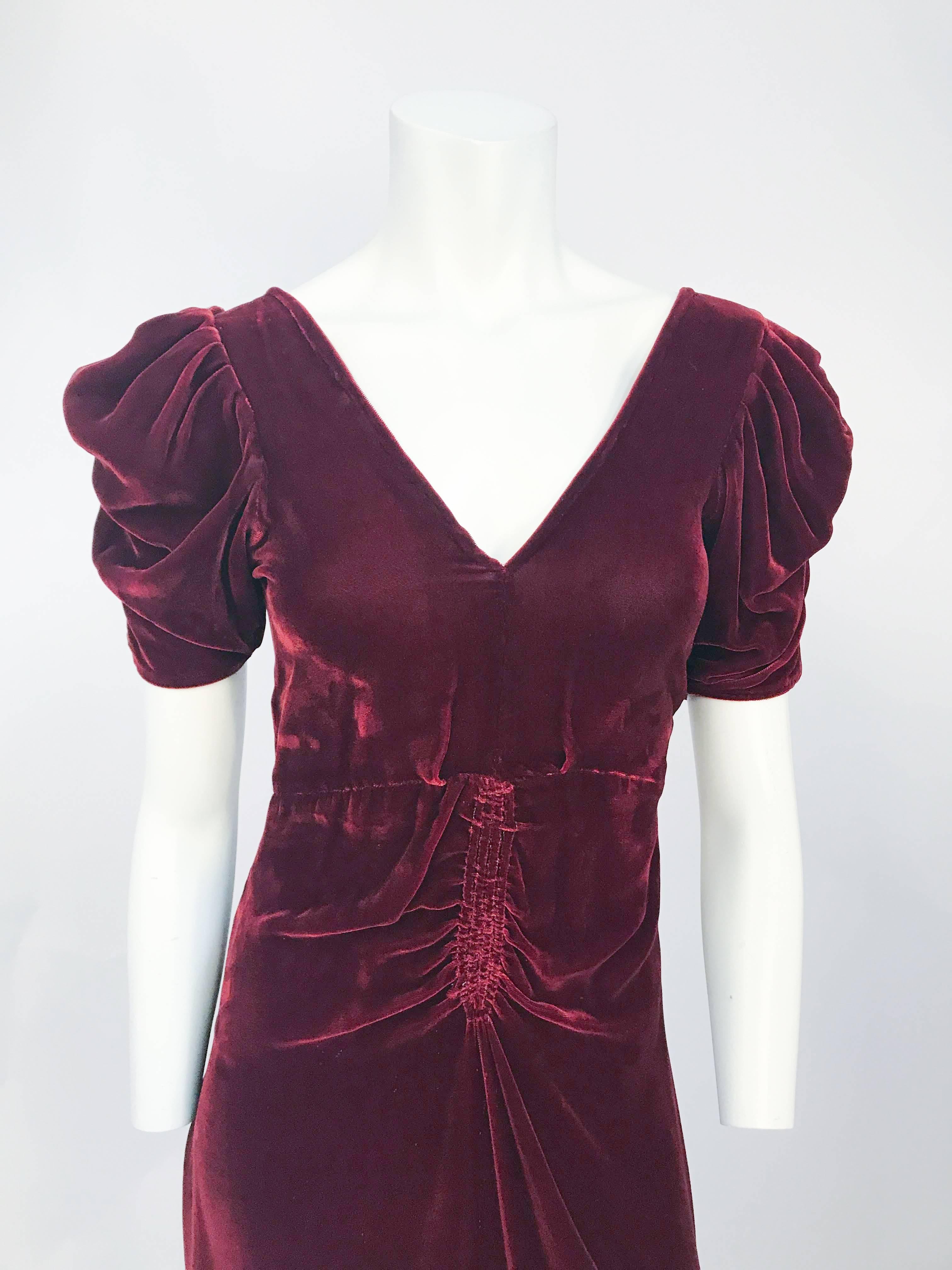 1930s very Dark Rust Silk Velvet Ruched Evening Gown. Sleeves have been draped into folds that almost extend to the elbow. The bodice has a deep v-neckline and in addition the waist is emphasized by several inches of vertical ruching and attached