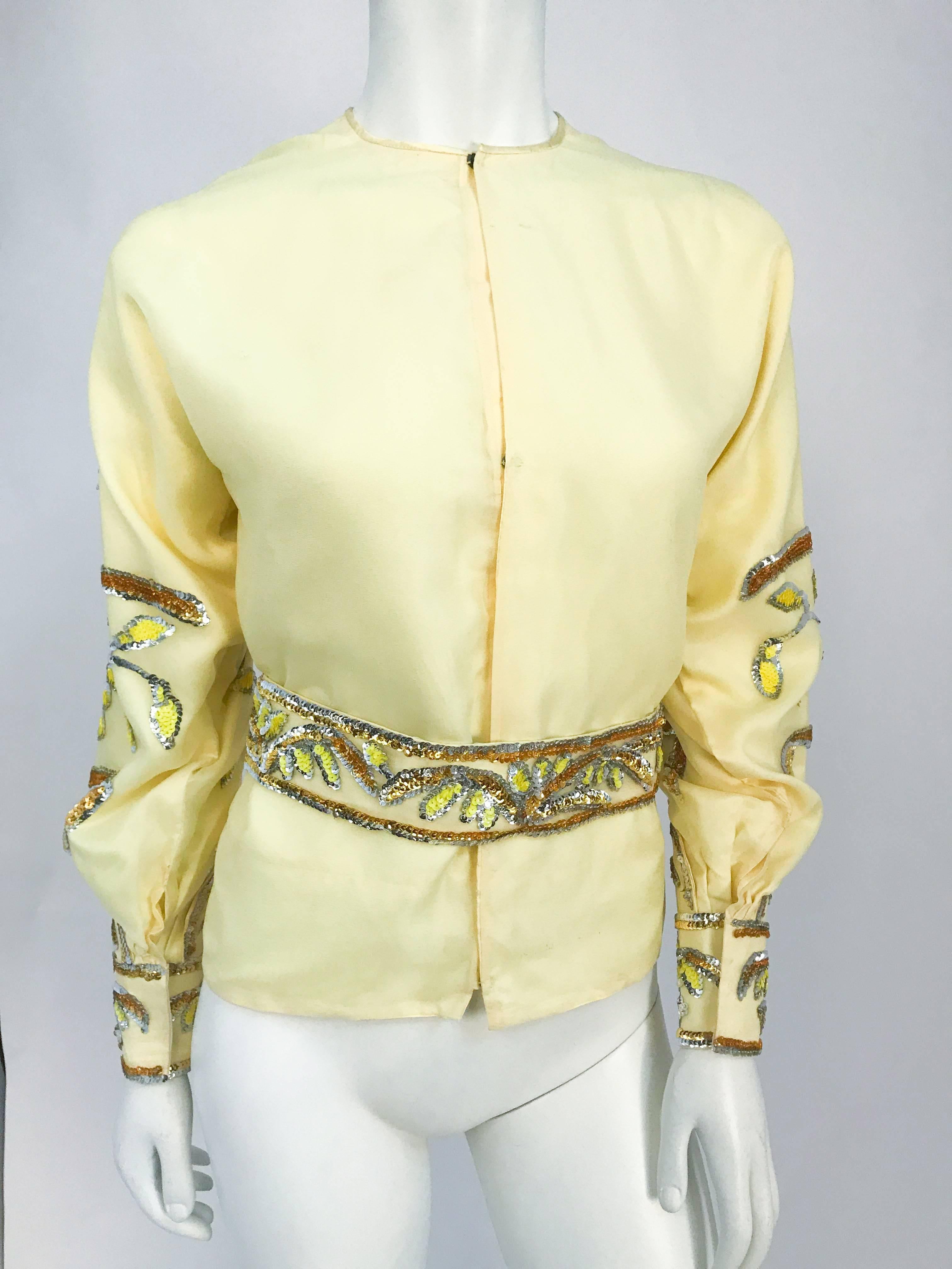 1960s Handmade Yellow Sequin Top and Belt Set with Flared Cuffs. Yellow theatrical costume piece with top adorned with sequin on sleeves, flared cuffs, and matching belt. Snap closure in the back