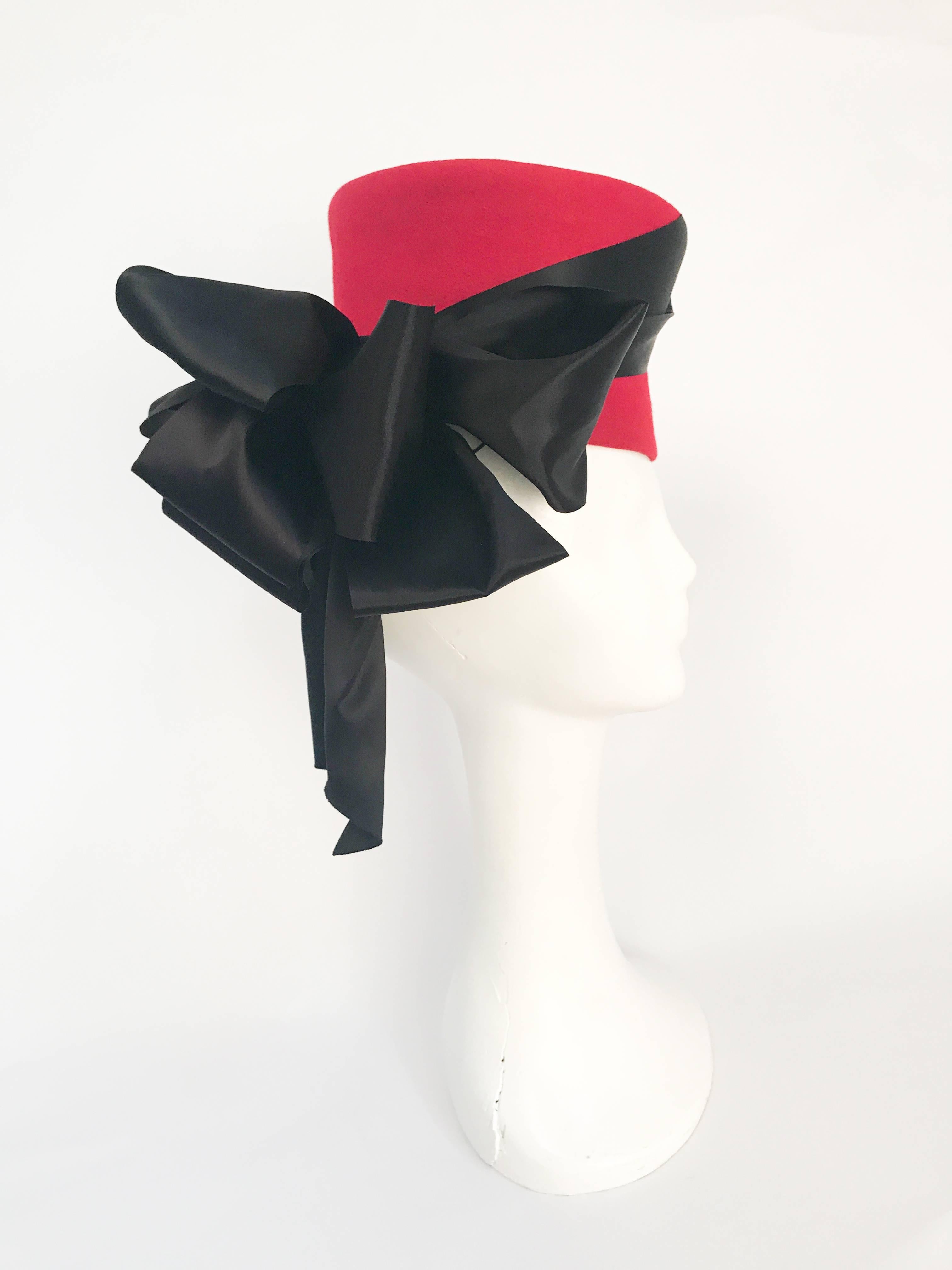 1940s Flora Weiler Rhubarb Red Tilt Hat with Satin Ribbon. Red tilt hat with black satin ribbon and exaggerated bow. Elastic provide to secure hat to head.