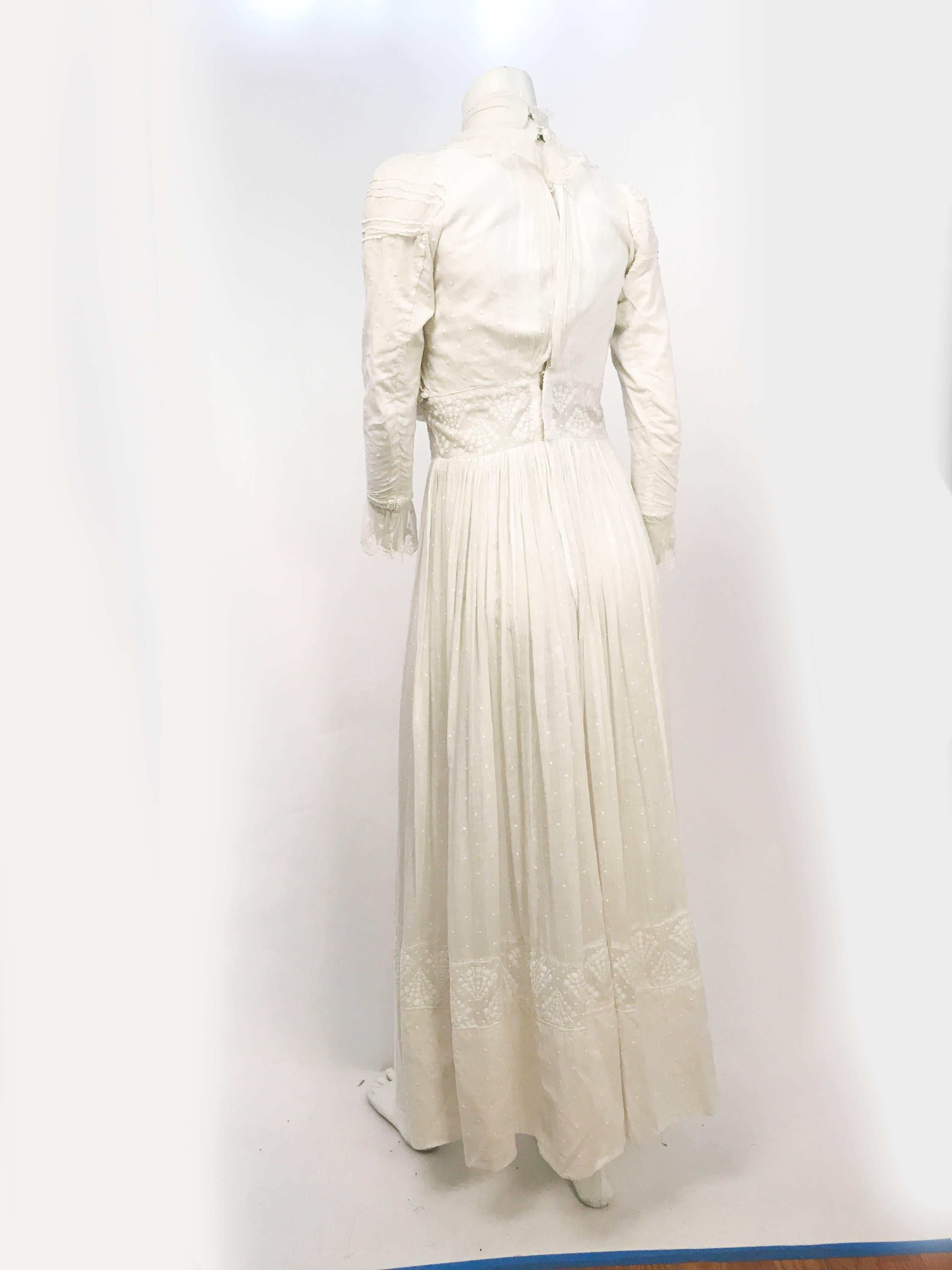 Edwardian White Wedding/Lawn Dress with Lace Details. White cotton dress with Swiss dot cotton, machine lace around the neckline and sleeves, and high collar. It has the classic pigeon bust shape, appropriate for Edwardian dresses.