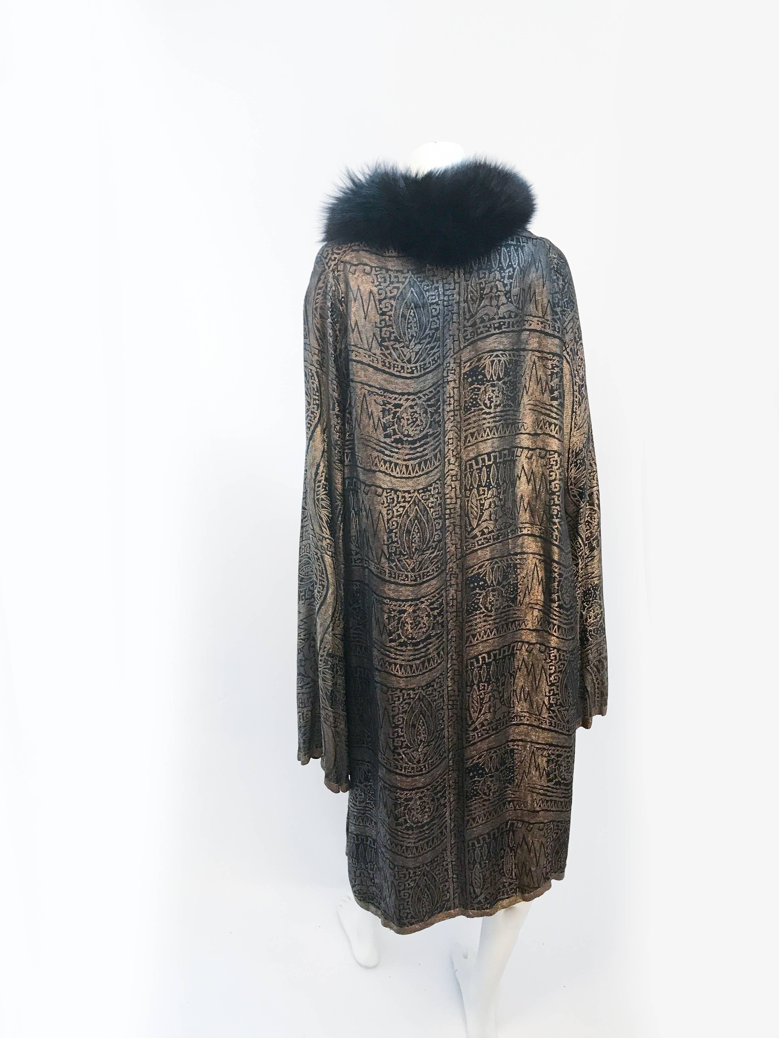 1920s Black Evening Evening Coat with Gold Lamé. Black evening coat with gold lamé. Imperial brocade trimmed in gold lamé. Black fox fur collar, trumpet sleeves (dramatic and extended), yoke lined in black silk. Made during novelty Egyptian Revival.