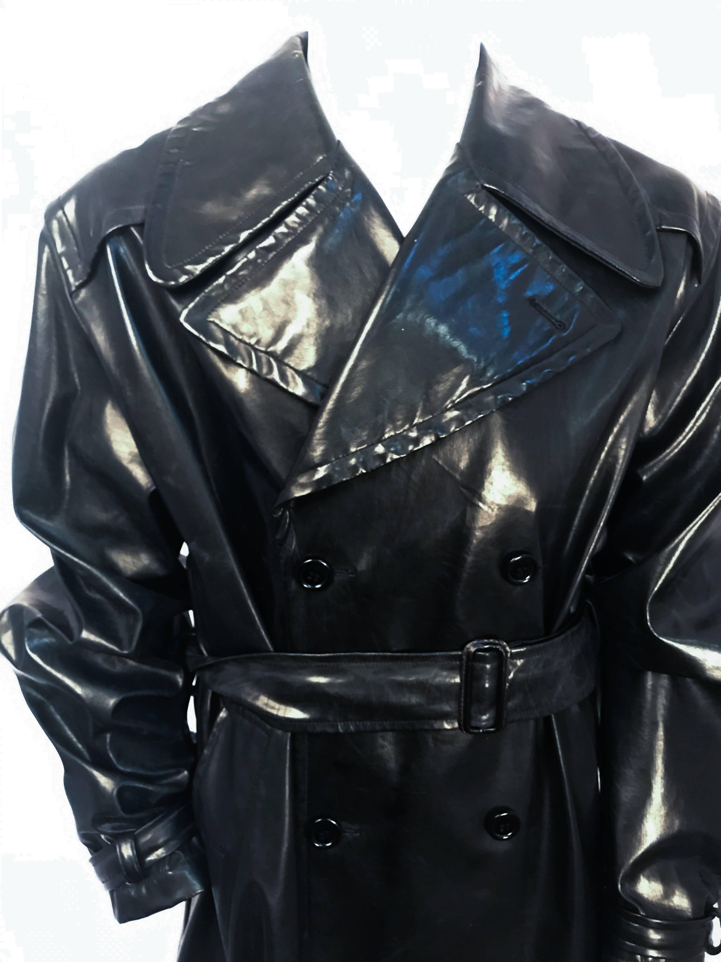 1990s Dolce and Gabbana Black Men's Leather Trench Coat Black waxed black leather trench coat with original sash and strapped cuffs.