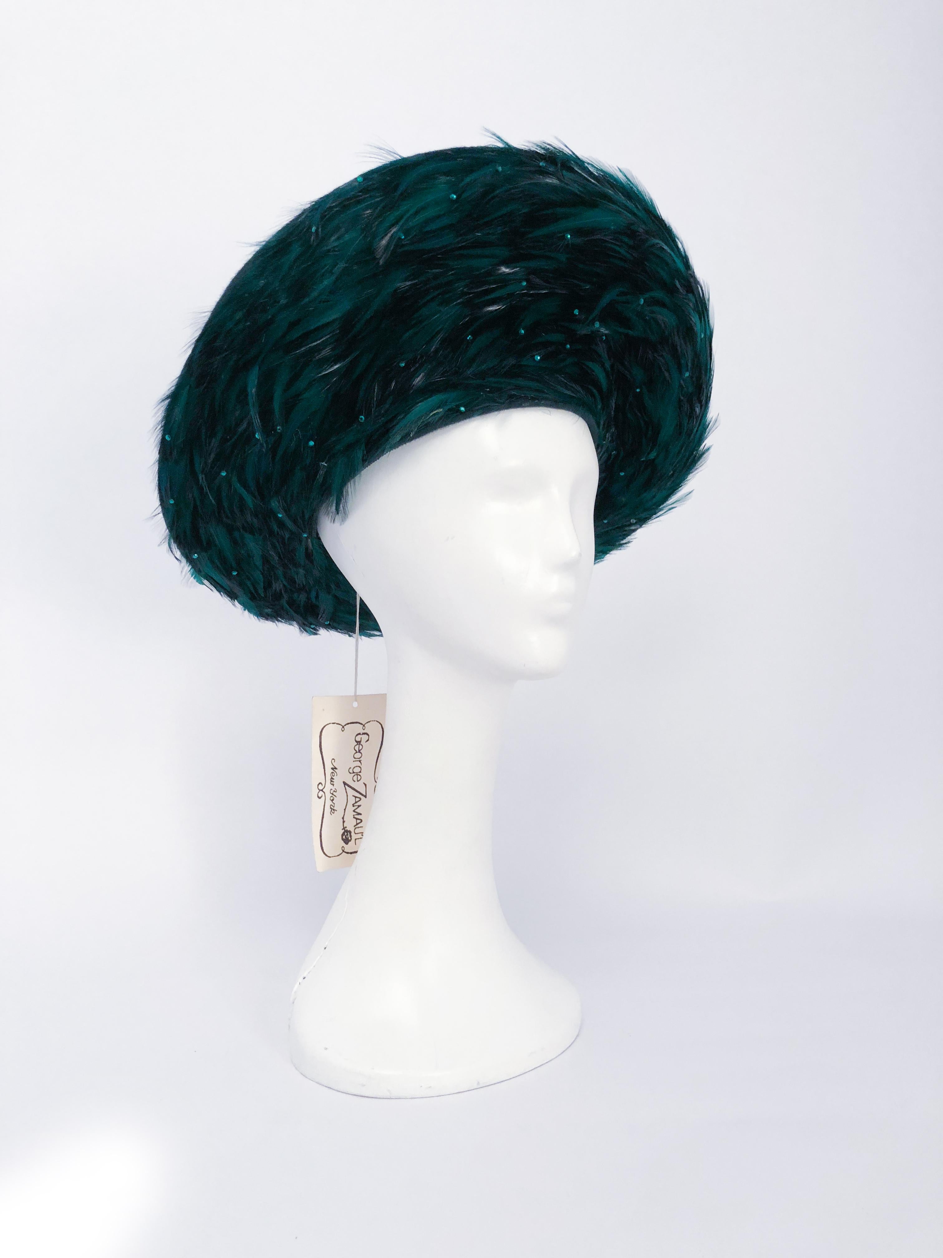 1980s George Zamau'l Emerald Hat with Feathered Brim. Emerald Green beaver felt hat with rhinestone jeweled black and green feathers on the underside of the brim. This hat is unworn and has the original tags attached. 23 inch circumference and could