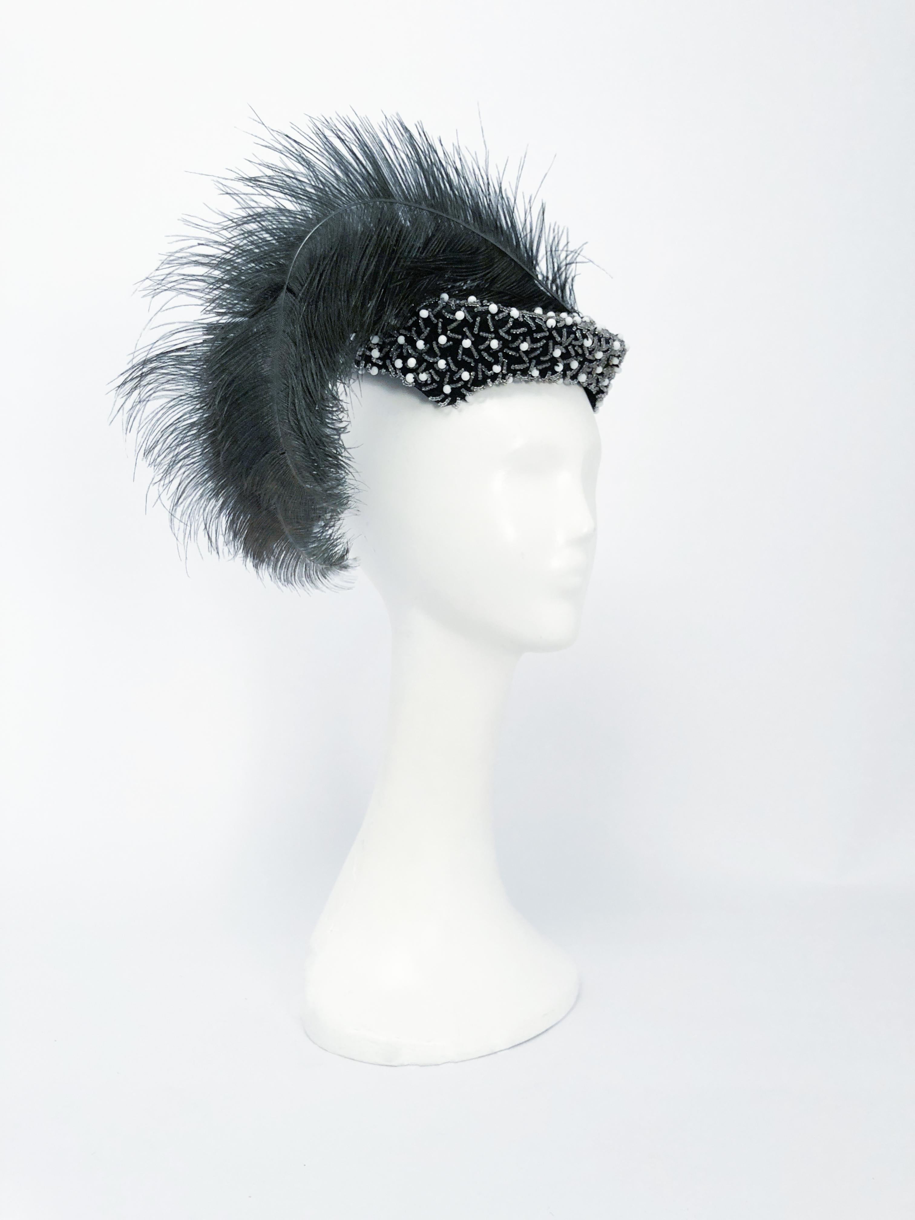 1950s Black Cocktail Hat with Hand-Beading and Grey Feather. Black cocktail hat with clear and milk glass hand-beading and unusual hand-dyed grey oversized feather. The hat can be molded to fit several sizes 