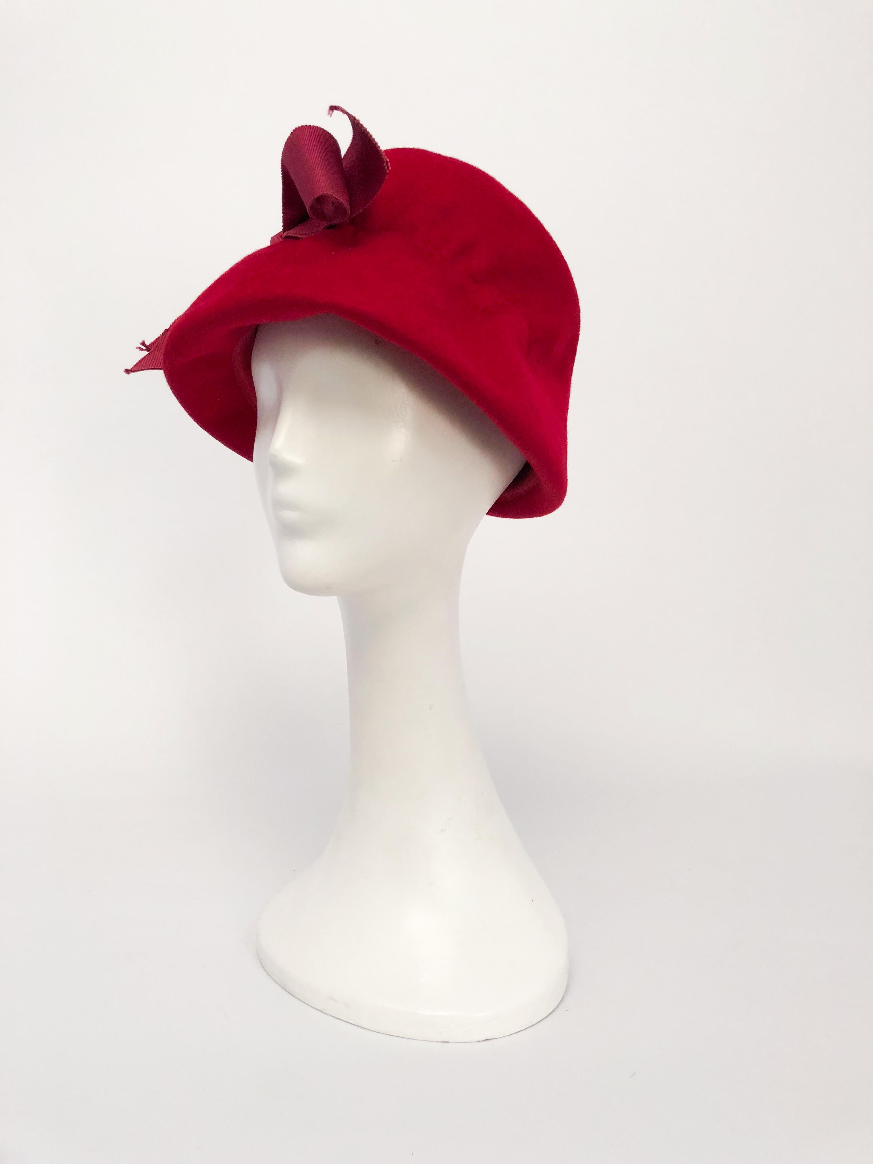 Cranberry beaver felt bucket hat with grosgrain ribbon with rucking to further shape the hat.