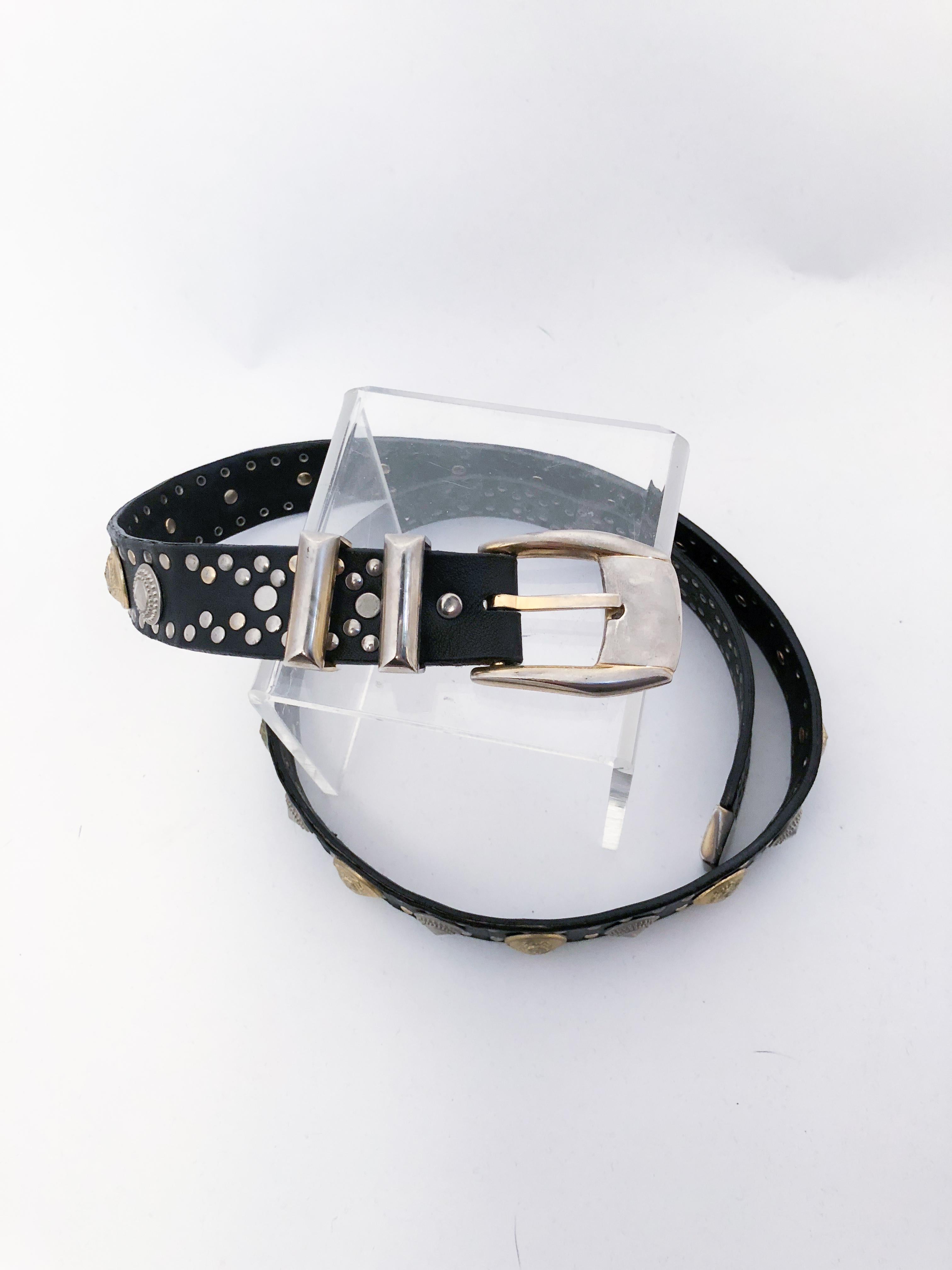 1990s Versace Leather Belt With Gold Medusa Head Studs. Black leather belt with silver and gold-tone studs. Also features large silver studs and gold-tone medusa head studs.