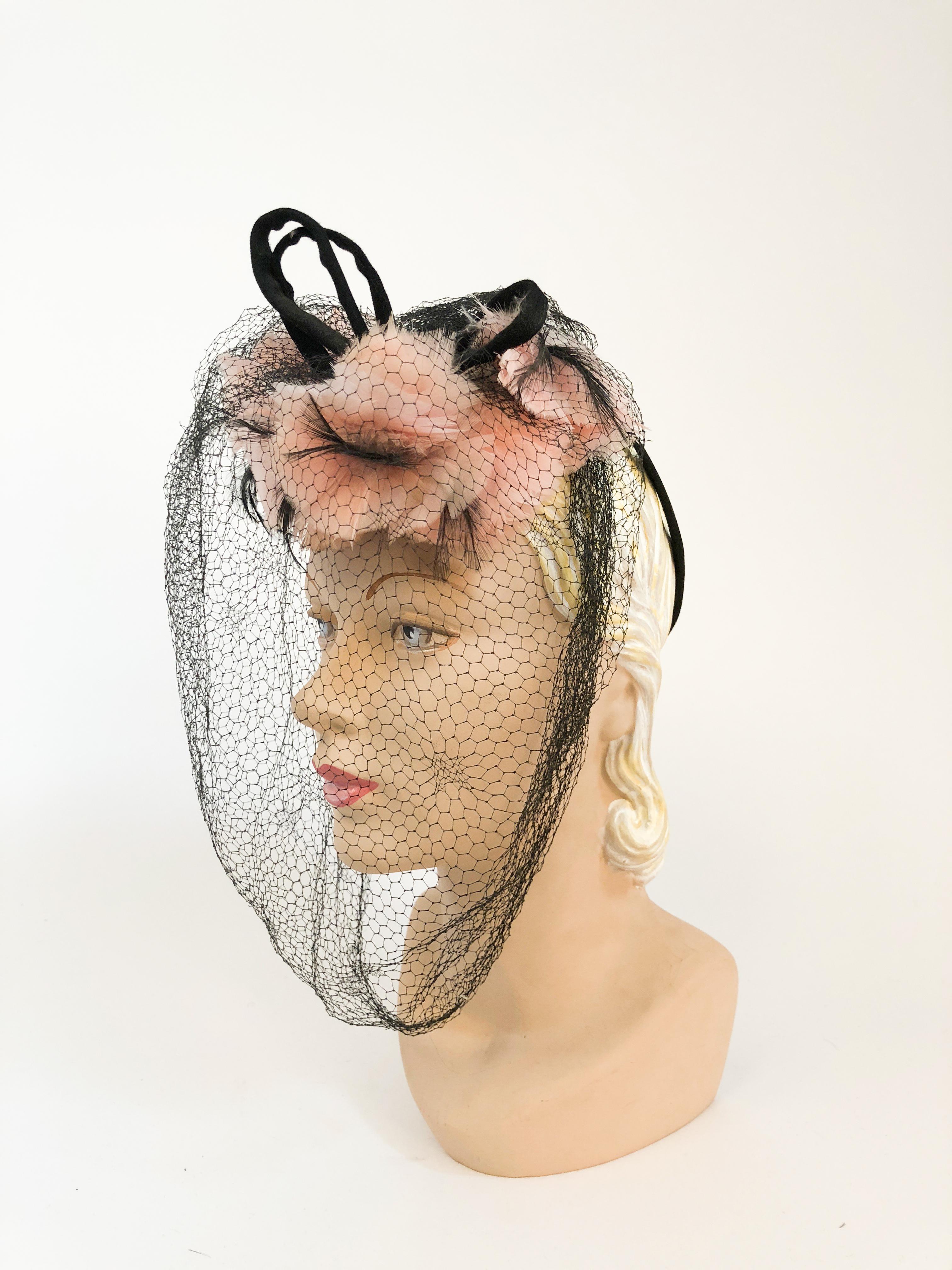 1940s Pink Feathered and Flowered Toy Hat. Pink Feathered hat with flowers and velvet detailing. Full face net and head circle clip to hold hat in place.