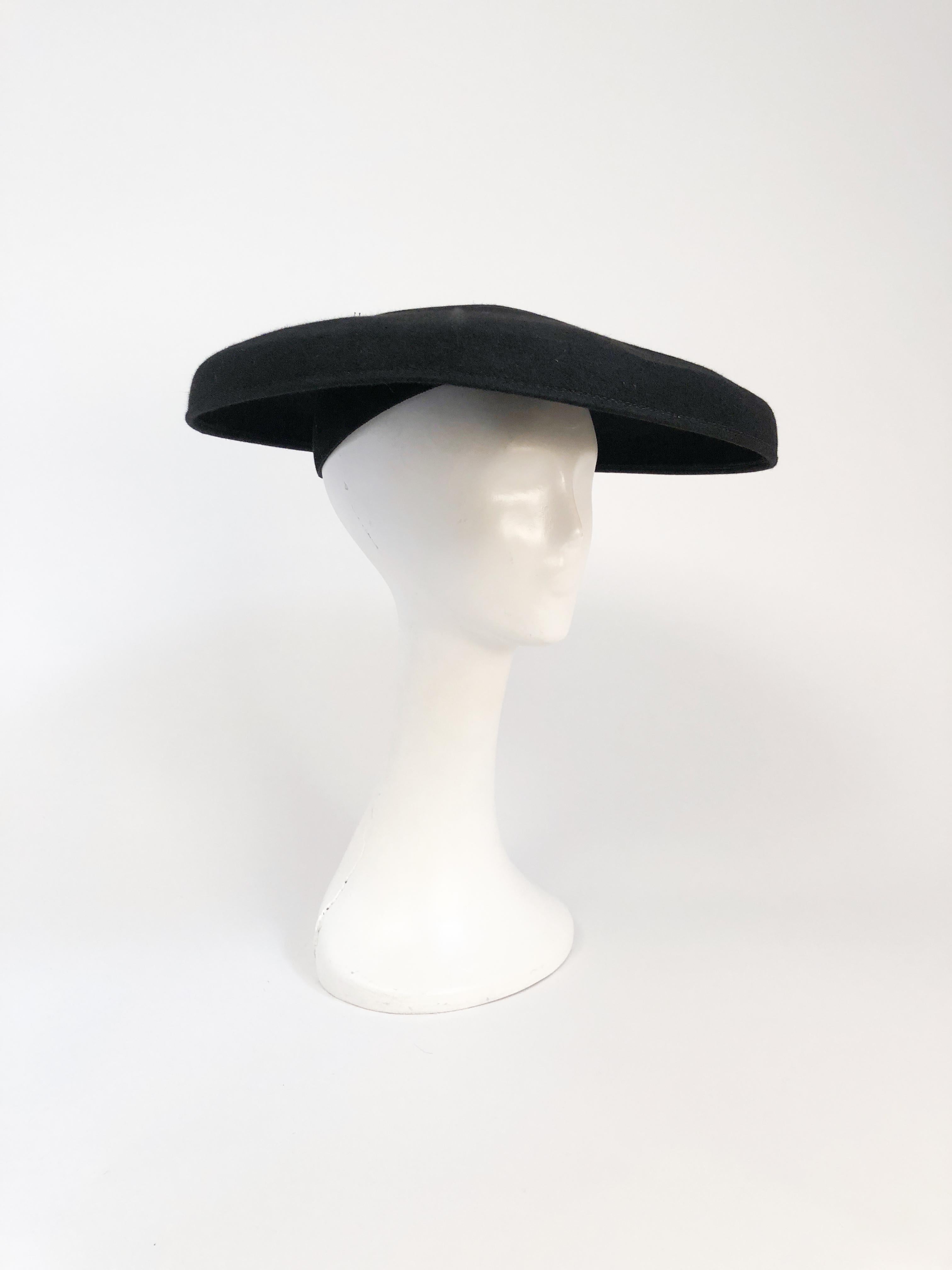 1940s Black Felt Cartwheel Hat. Black cartwheel hat made of beaver felt. Inner hat cap to secure hat to head. Gros-grain band and elastic.
