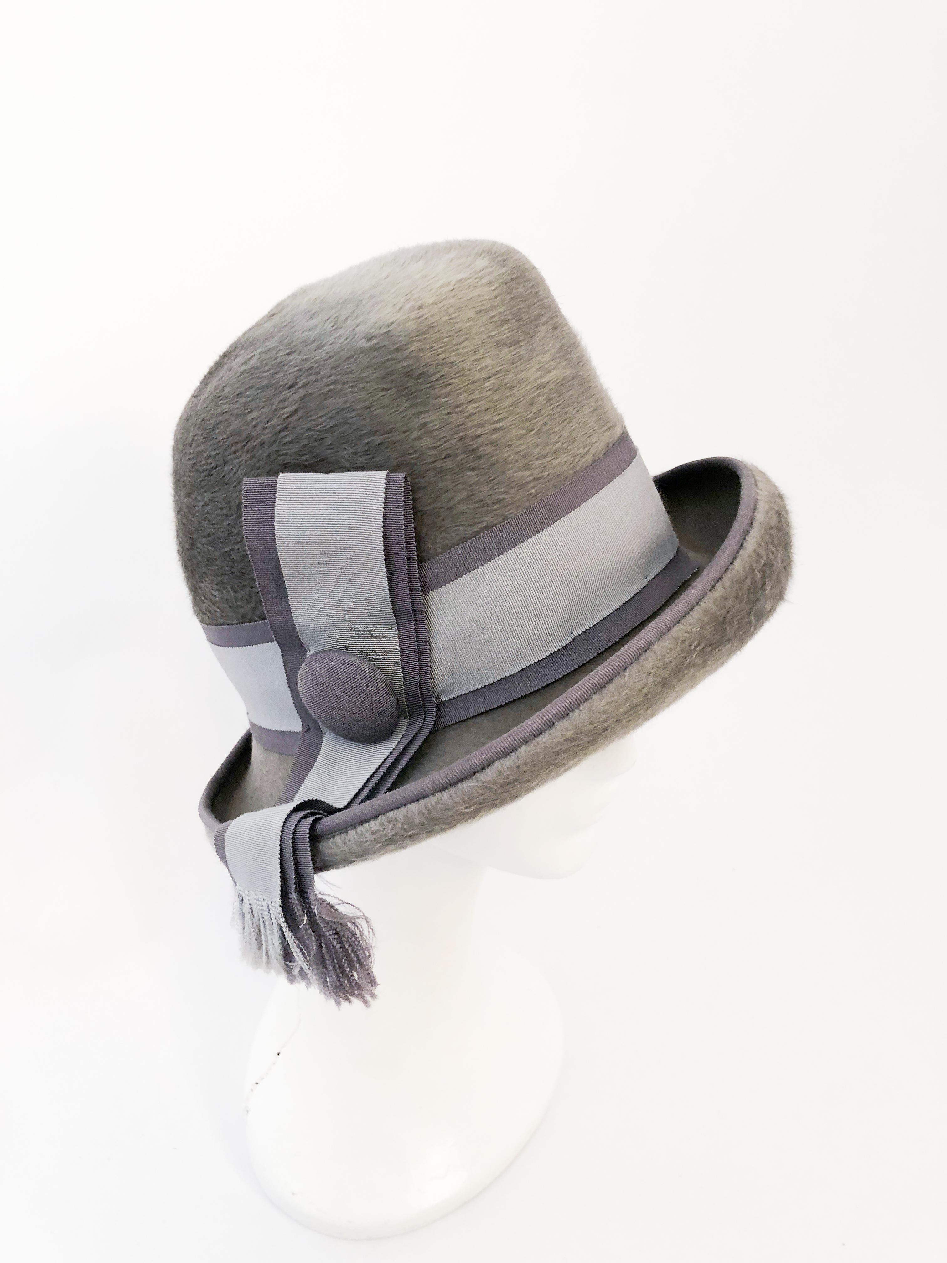 1960s I. Magnin Grey Beaver Felt Cloche. Grey beaver felt hat with two-toned gros-grain band with covered button accent. 