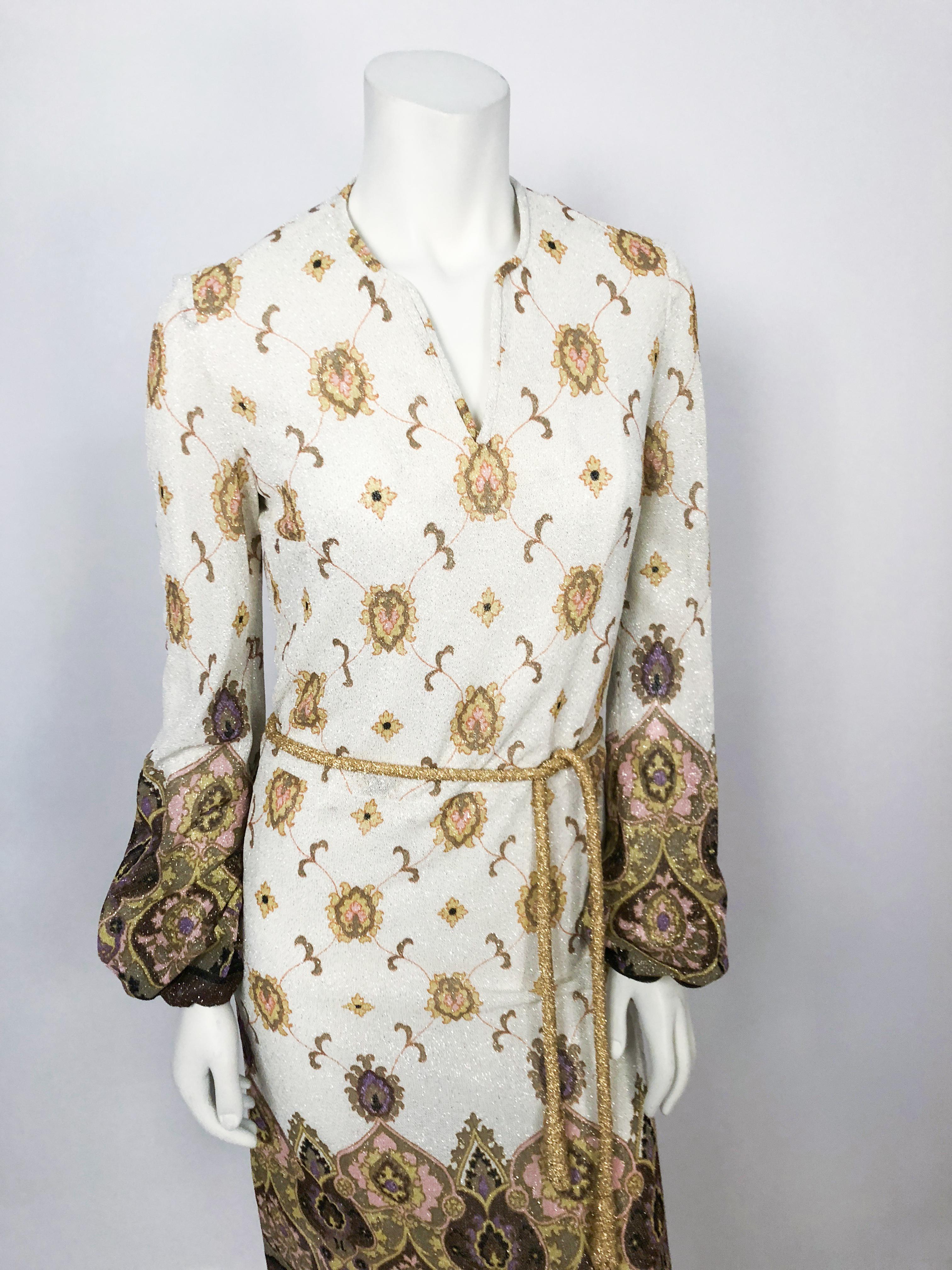 1970s Printed Cram and Pink Dress With Matching Belt. Boarder Printed dress with matching rolled gold cord sash, gathered rists, and full lining. The fabric has a silver lurex shine in it. 