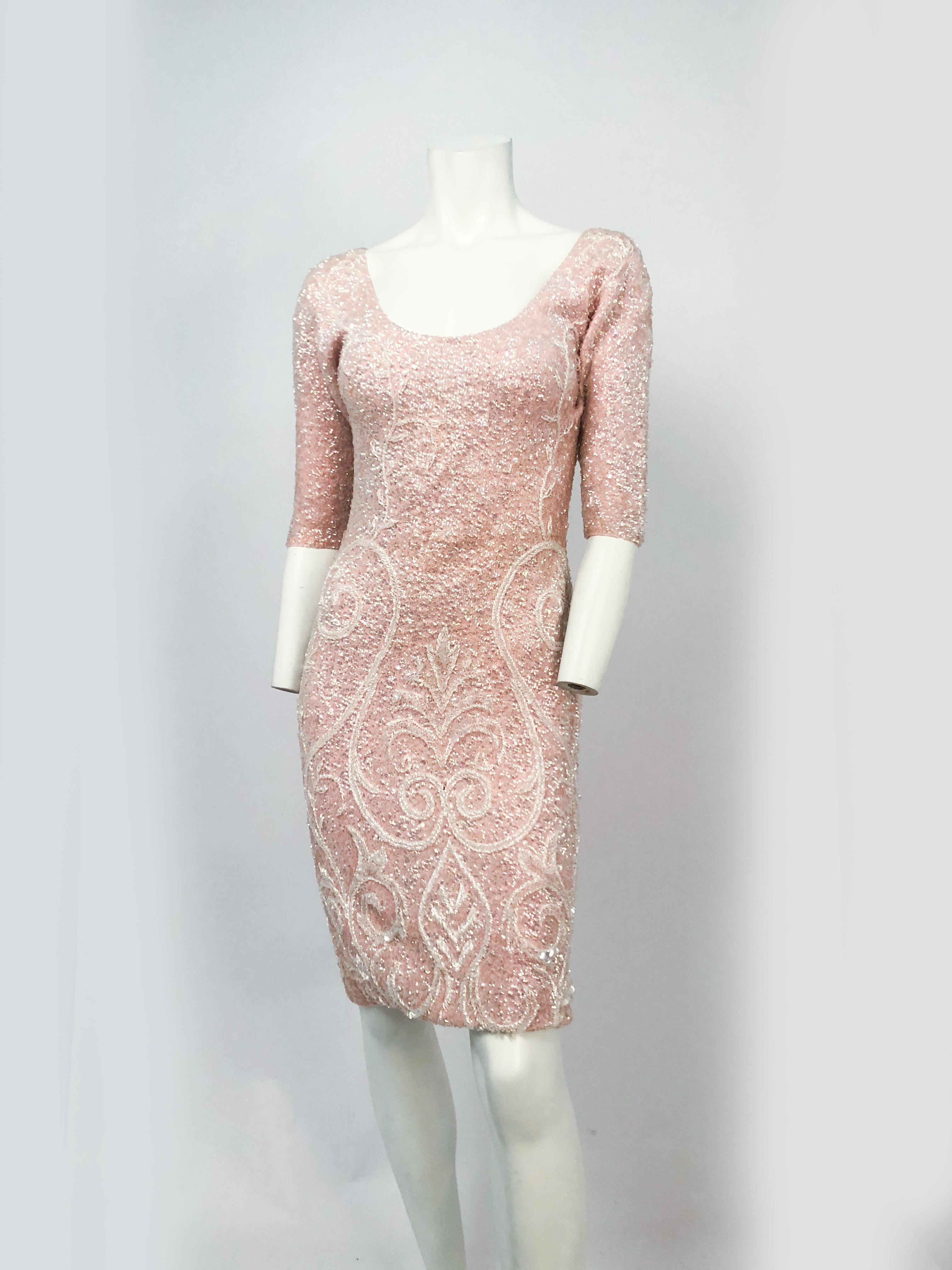 1960s Bink Sequin and Beaded Knit Dress. Features hand white beading and iridescent sequin, elbow length sleeves, and a scoop neck.