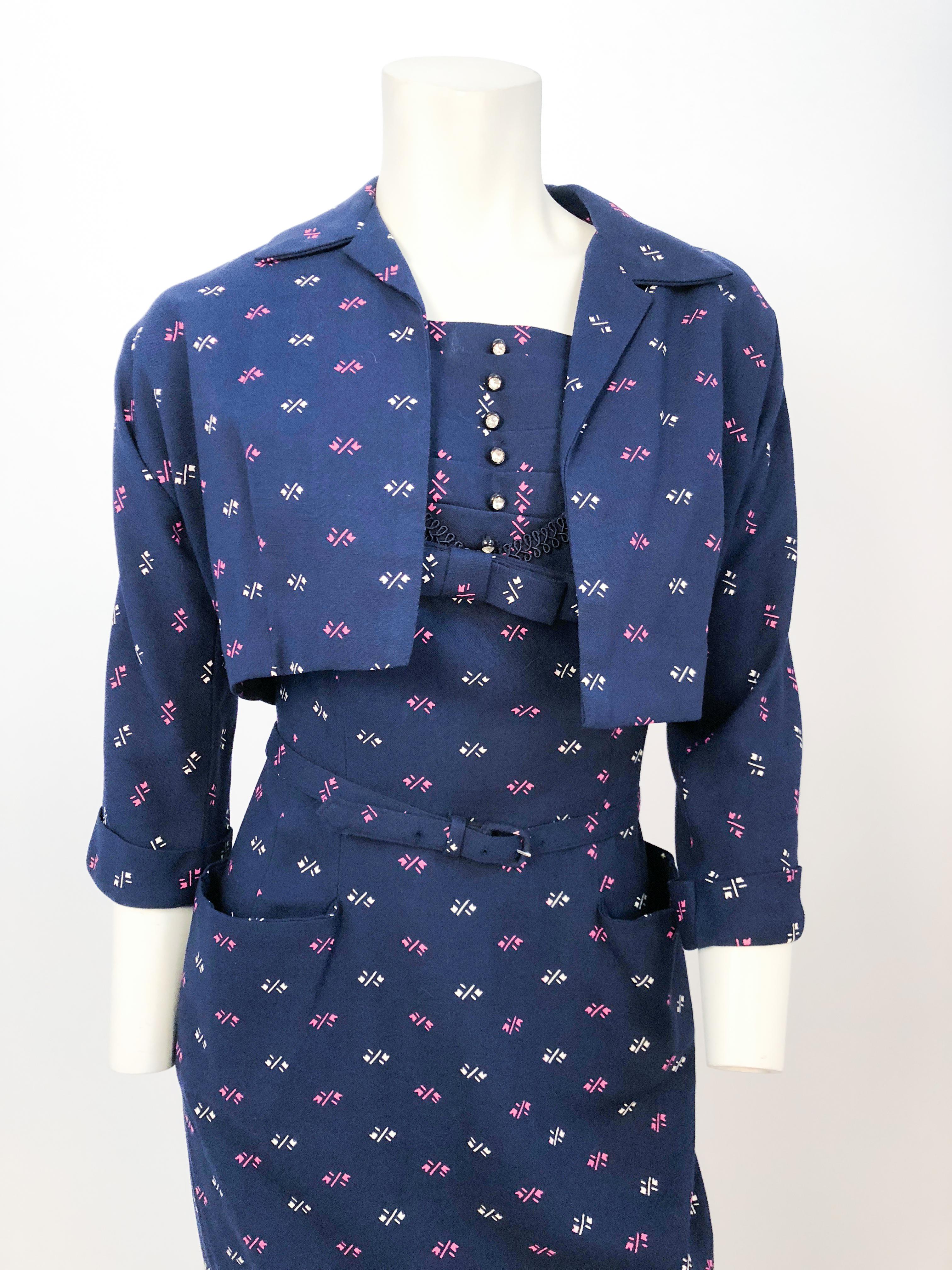 1950s navy printed 3-piece set (Bolero, dress, and belt) with oversized pockets, rhinestone buttons, bow, decorated bib wit pleats, trimming and 3/4 length sleeves.