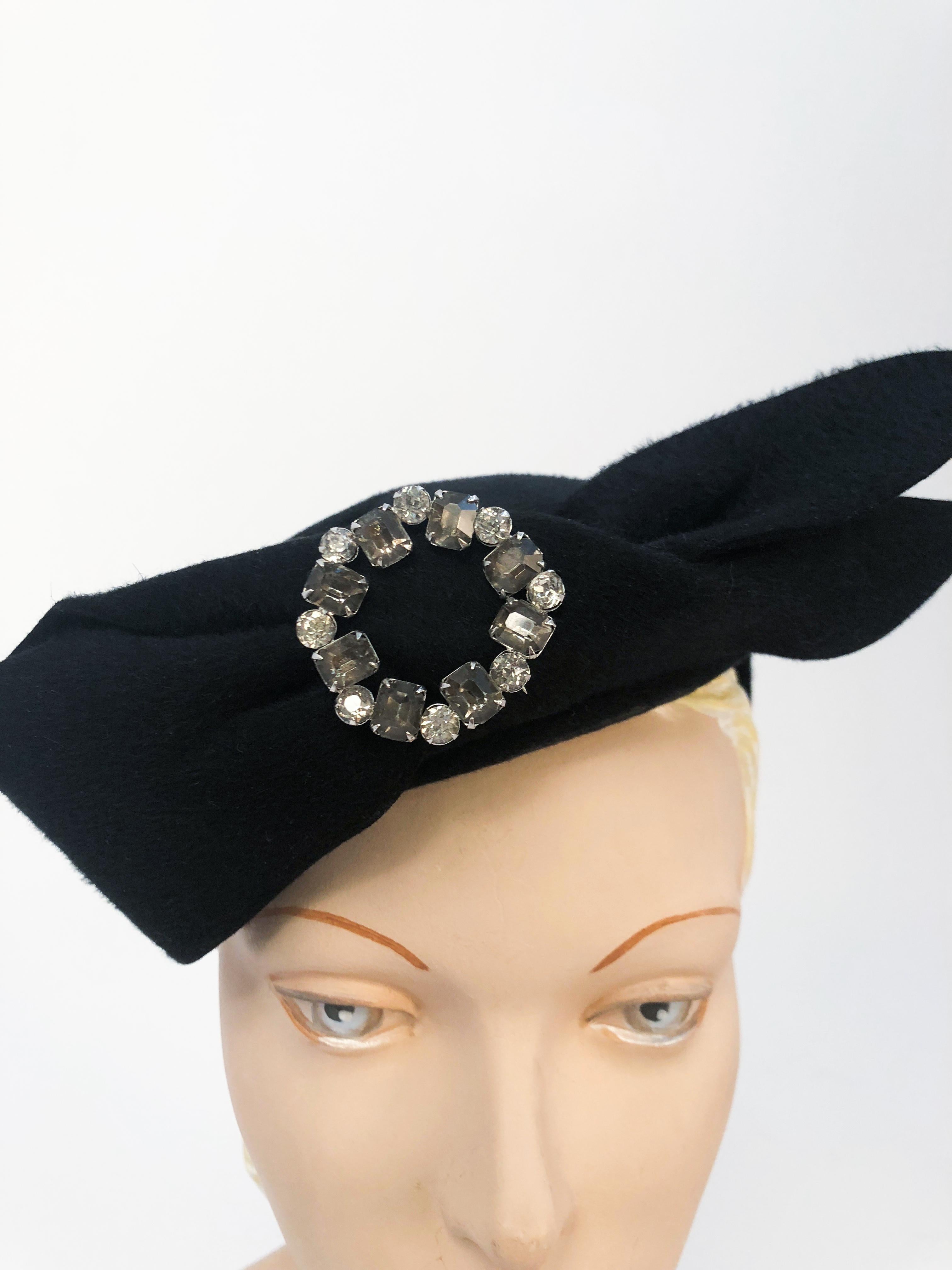 1950s Black Fur Felt Cocktail Hat with Oversized Bow and Rhinestone Accent. Accent features clear and soft grey rhinestones.