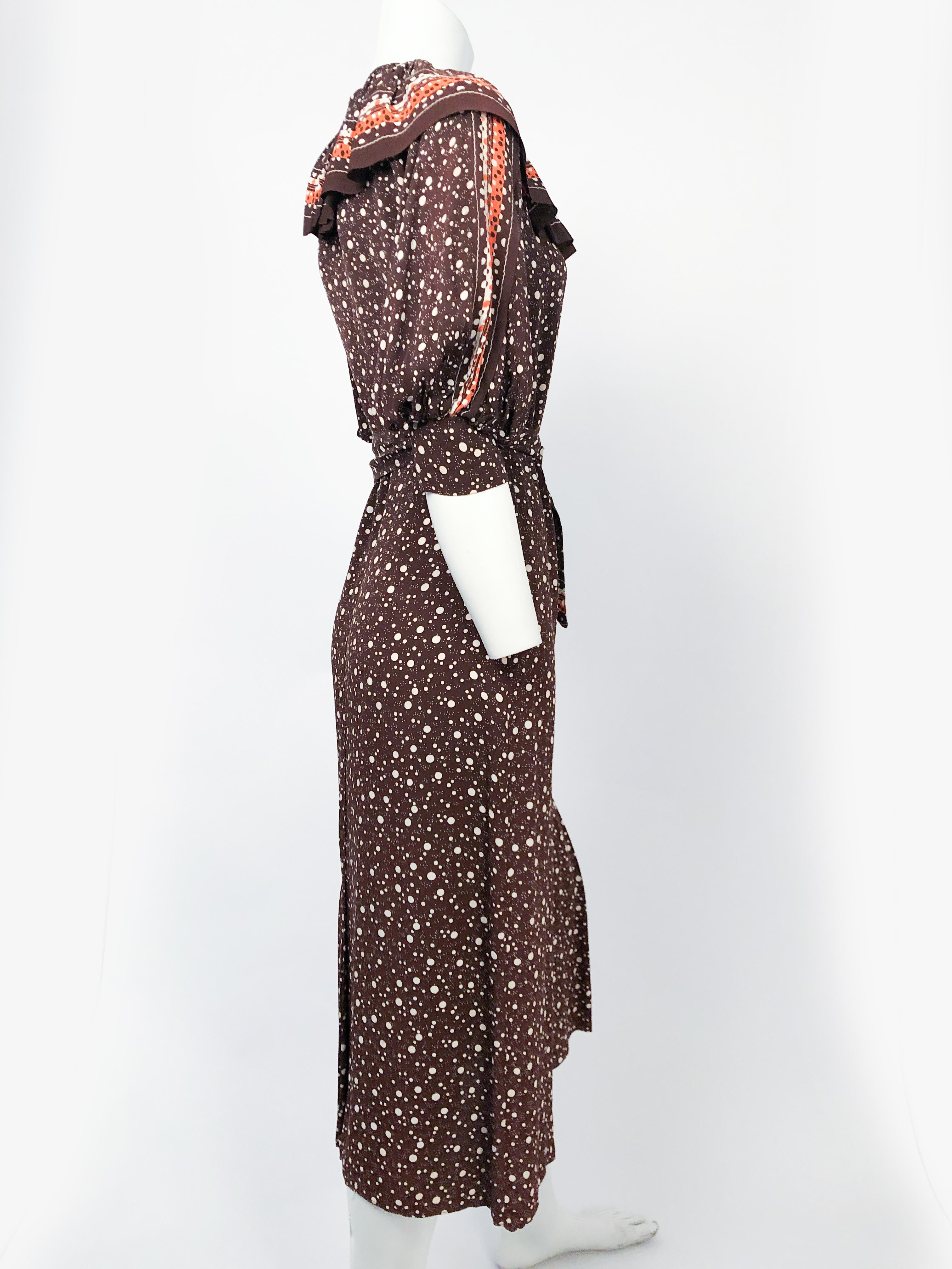 1930s Brown Polka Dot Printed  Crepe Dress with oversized ruffled capelette collar, orange/beige boarder print, cuffed/puffed sleeves, and double-sided sash belt. 