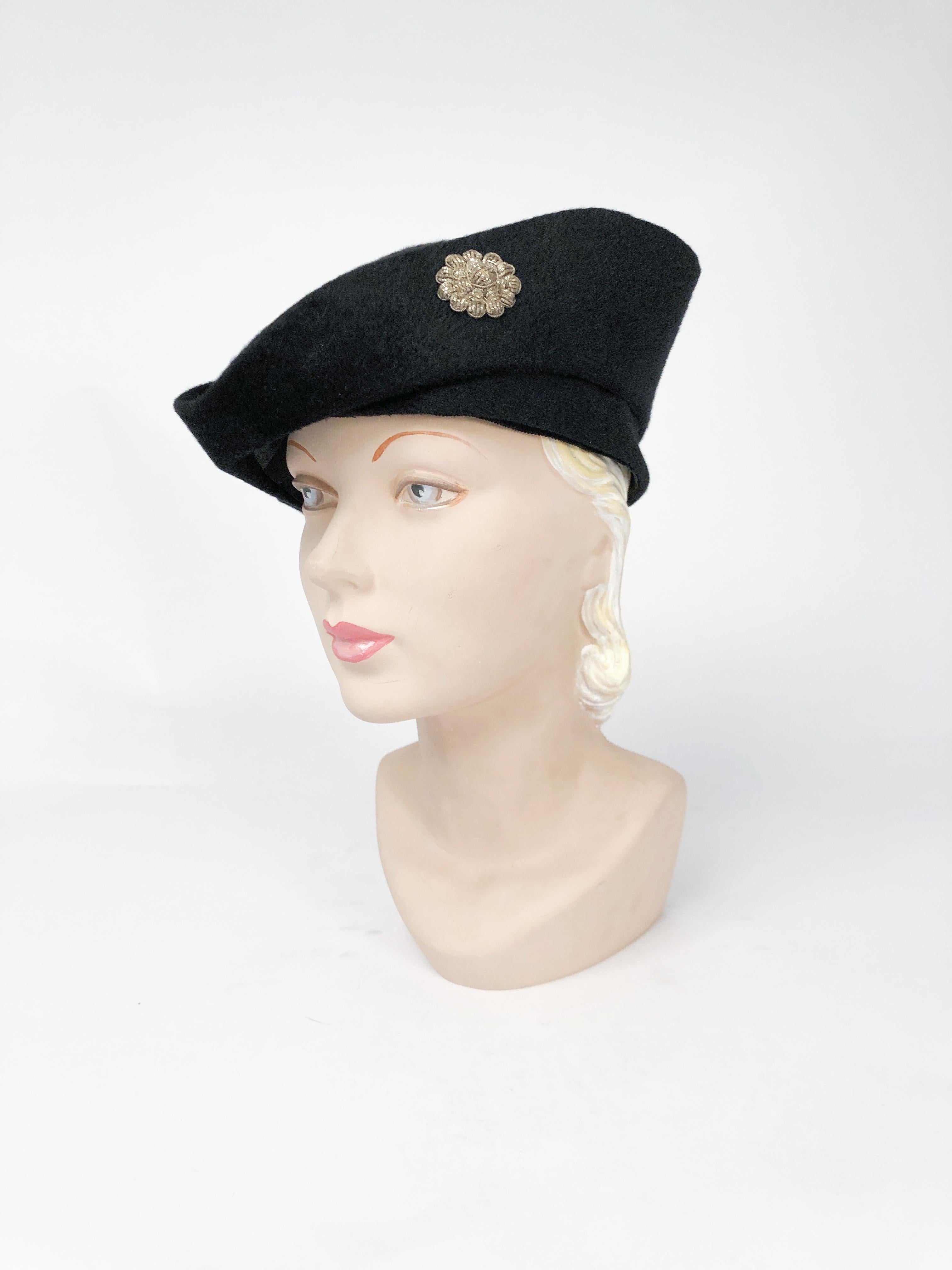 1930s Black cashmere felt hat with traditional pirate shape. Sterling Silver flower accent on the side of the brim.