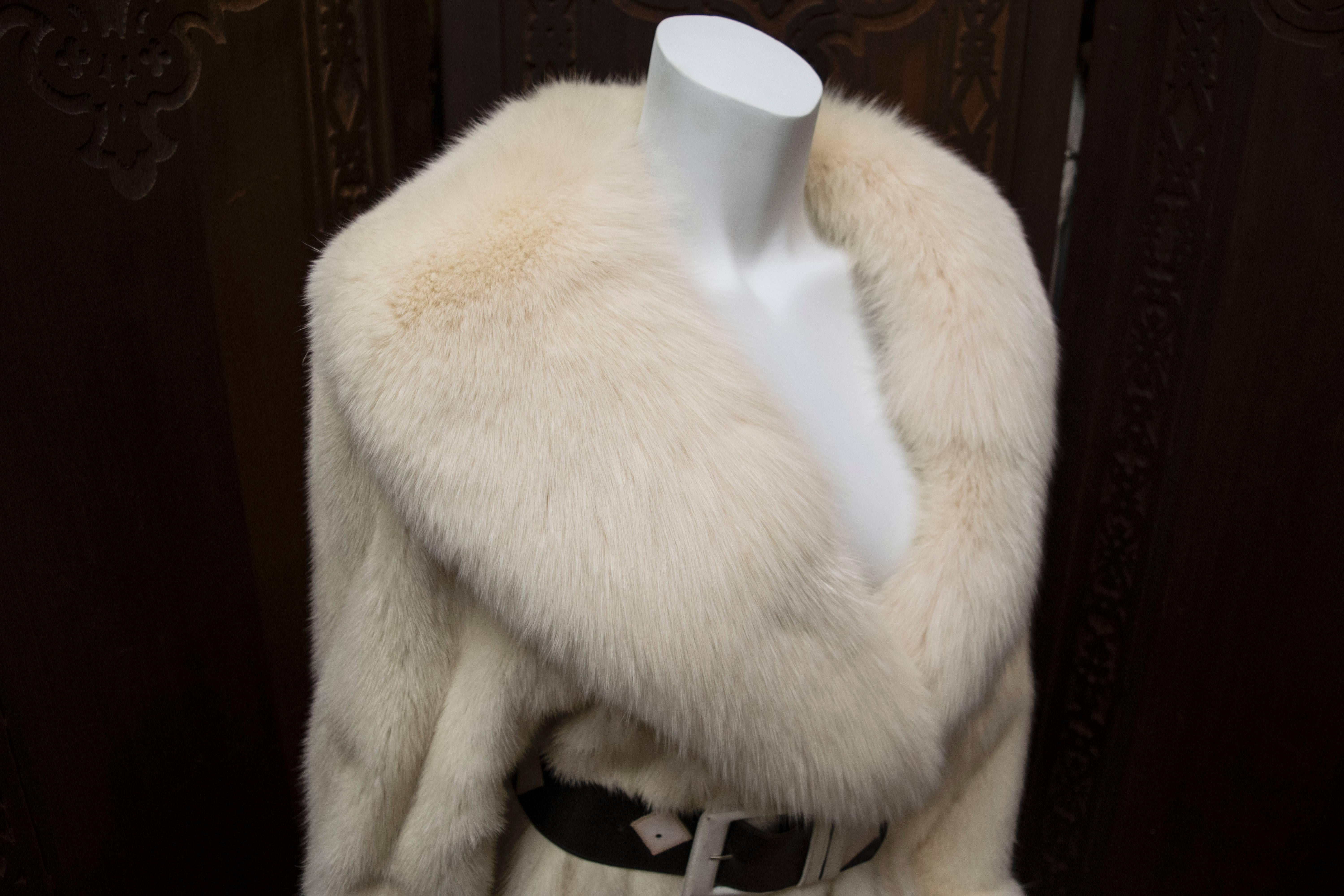 Stunning Christian Dior Fourrure Fox Trimmed White Mink Fur Coat. 
A luxurious long white mink fur coat trimmed with exquisitely plush white fox fur. Shown belted for styling; Belt can be purchased. 

B 40
W 40
H 44
L 50