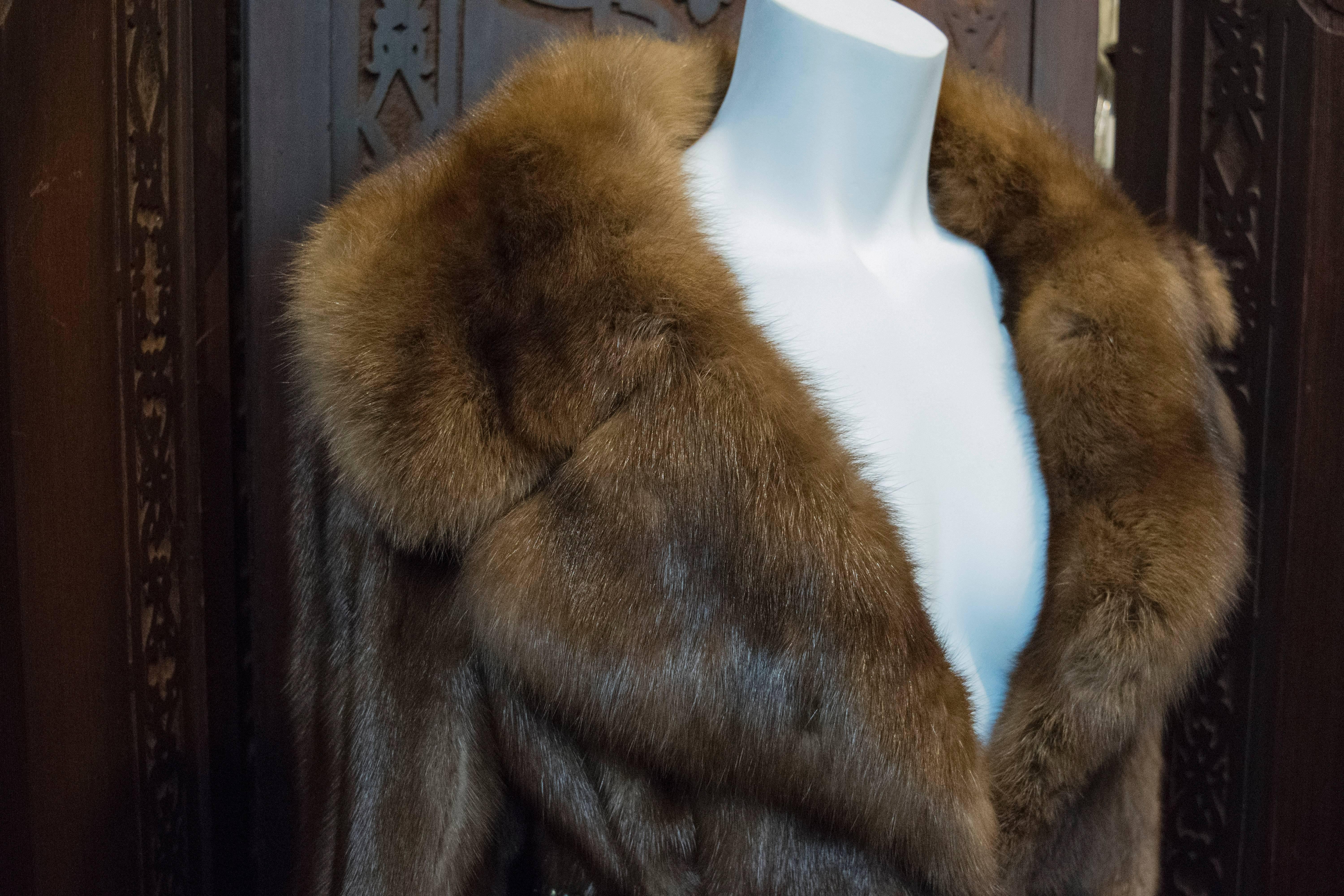Mink and Sable Trimmed Fur Coat.
A gorgeously soft and silky mink fur coat trimmed with Sable with a beautiful shine. The coat is shown belted for styling. Belt can be purchased. 

B 40
W 40
H 44
L 50