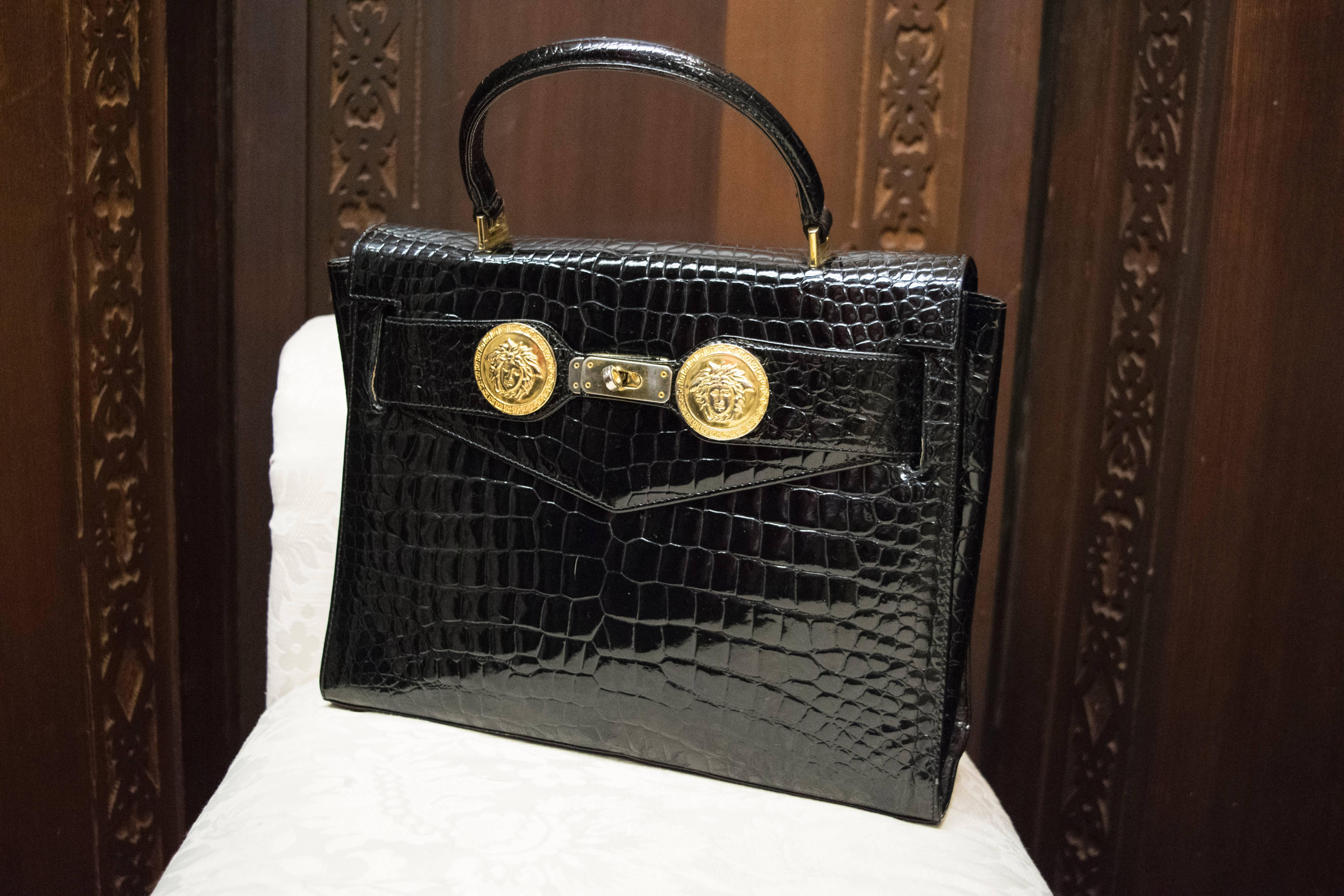 1980s Gianni Versace Embossed Crocodile Handbag.
A sleek and elegant Versace embossed Crocodile handbag with beautiful Medusa head detailing. Comes with dust cover and shoulder strap. 
Slight tarnish on clasp.  

W 12
H 9
D 4