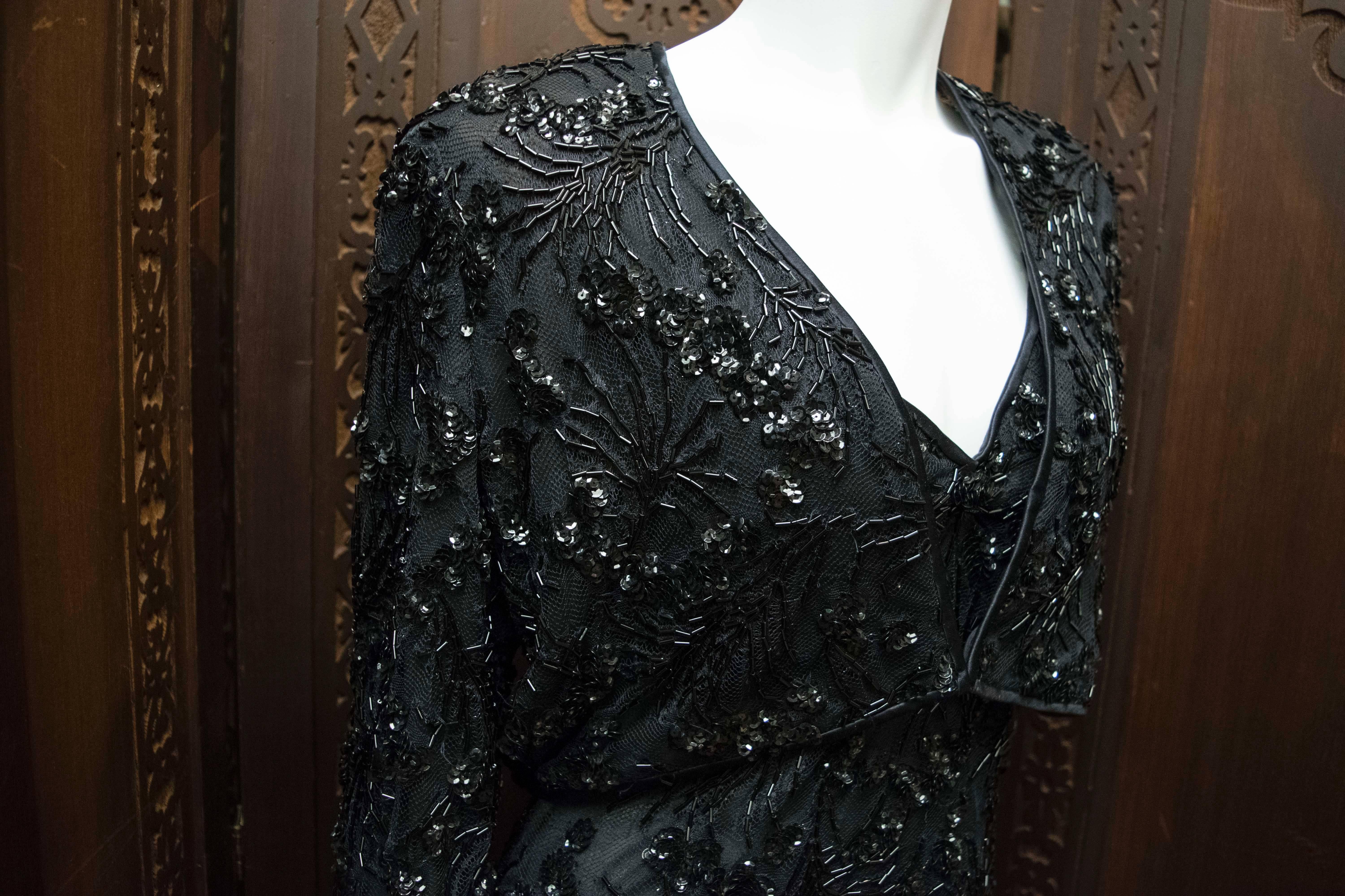 1980s Bob Mackie Black Beaded Two Piece Cocktail Dress and Bolero.
A stunning two piece designed by Bob Mackie. The dress and jacket are covered in hundreds of black beads in a floral pattern and look beautiful together or separate. 
