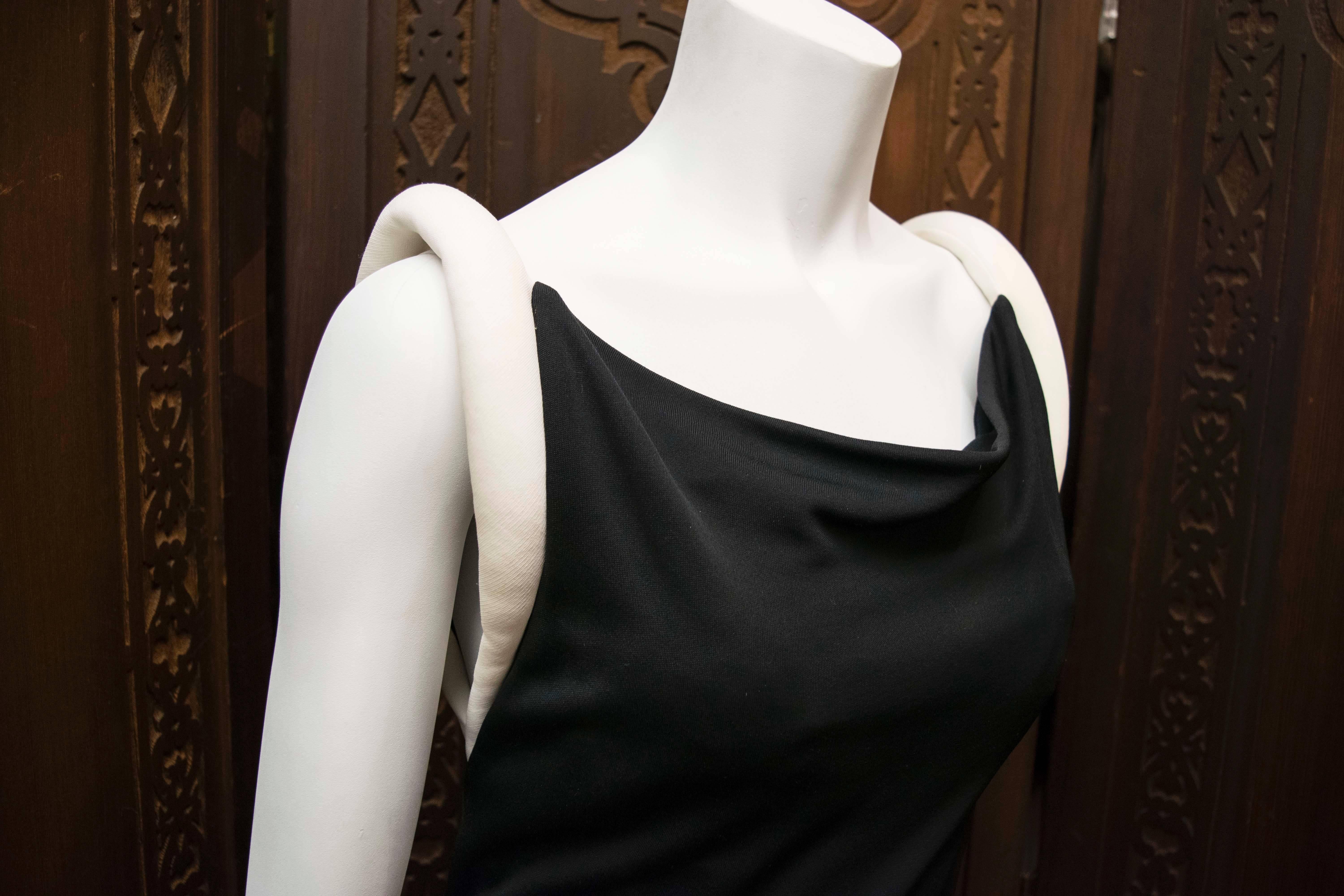 1980s Giani Versace Couture Black Cocktail Dress.
An interesting vintage Giani Versace black cocktail dress. This piece feels both retro and current at the same time, and is a wonderful piece of wearable fashion memorabilia.

B 30
W 28
H 34
L
