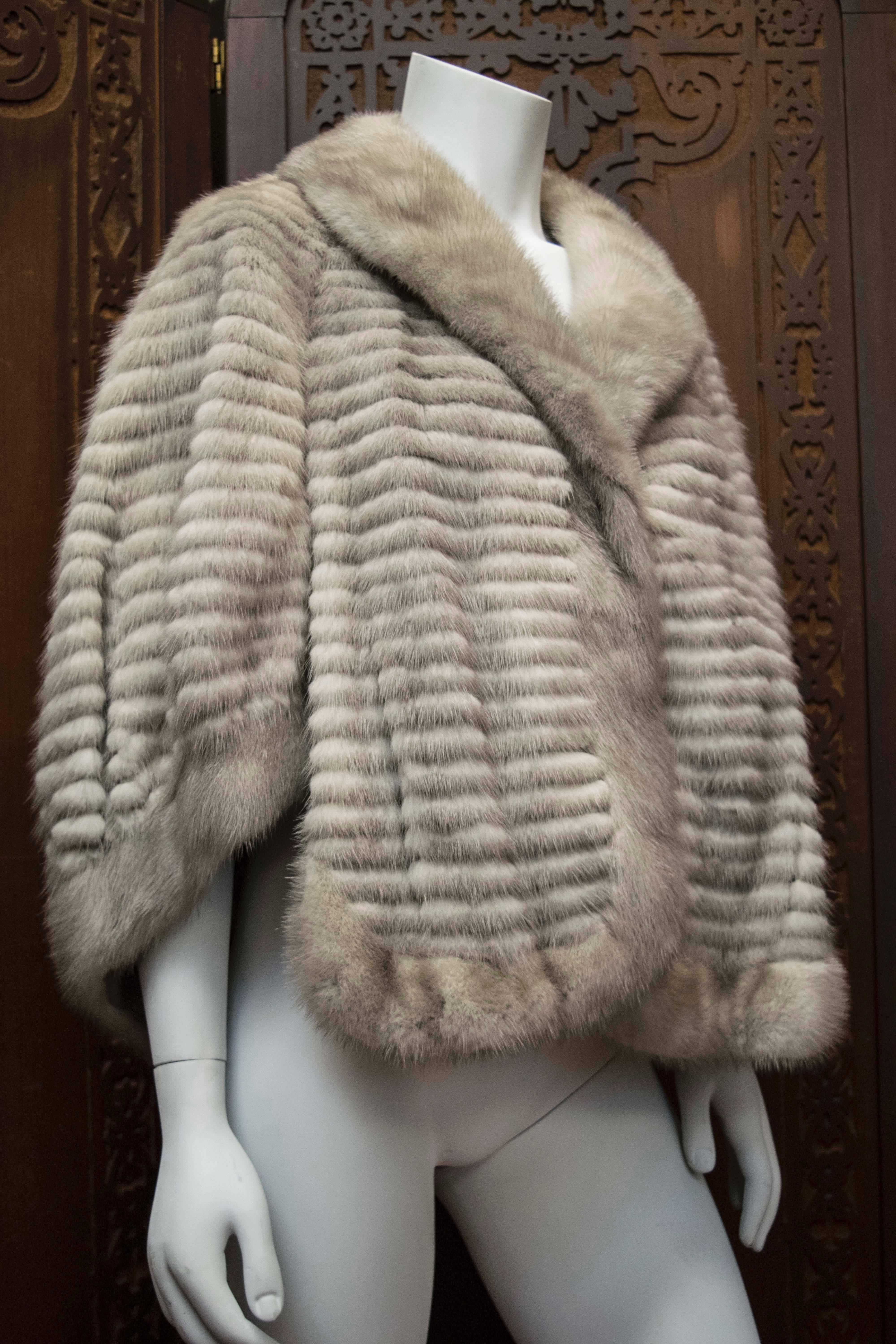 Grey Razored Mink Capette 

Beautiful fur and rare colour this piece has a shawl collar and cut outs for your hands to go through. Great for autumn or winter, this piece would be perfect for any fur connoisseur. 

Small spots on the lining.  