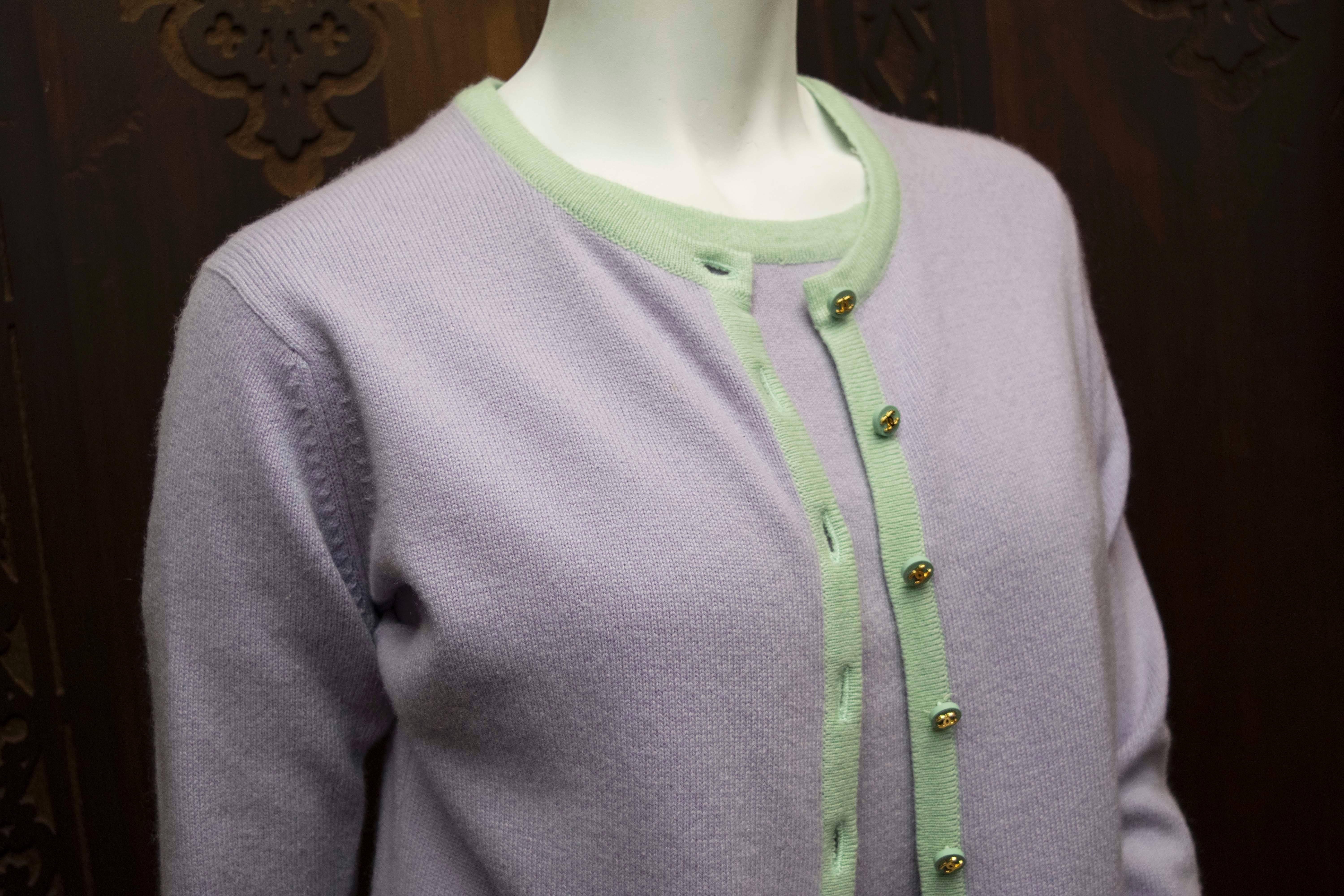 Chanel Cashmere Two Piece 

Pastel coloured Chanel Cardigan and top with gold detailed buttons and two pockets with matching button closures. 

B 32
W 30
L 21 
