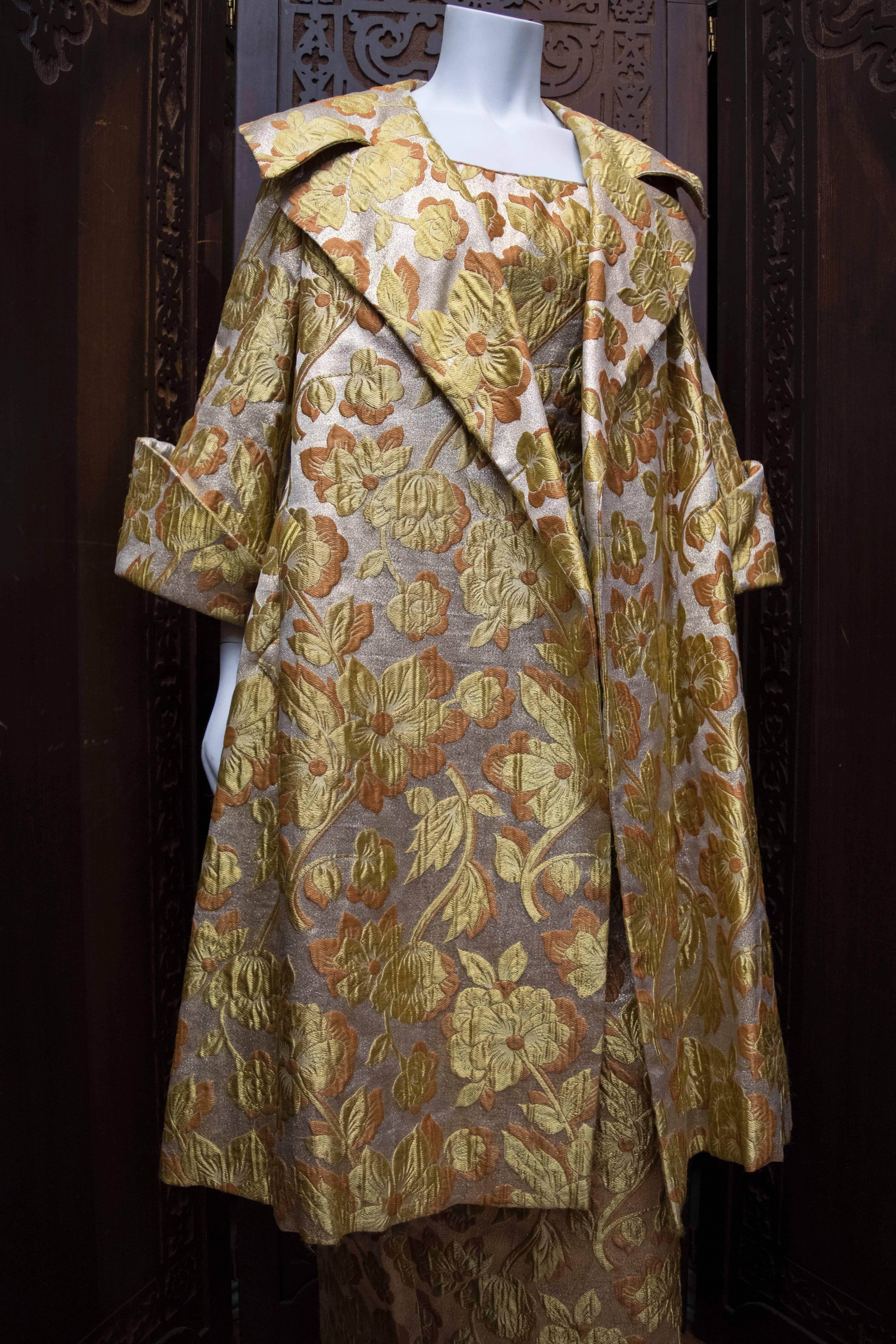 Mr Blackwell 1960s Gold Brocade Evening Dress and Coat.

Incredible Mr Blackwell circa 1960s evening dress and coat! Shimmery lamé brocade in a floral motif! Nice wide-cut sleeves and lapels. Excellent feel and weight to the fabric, lined in