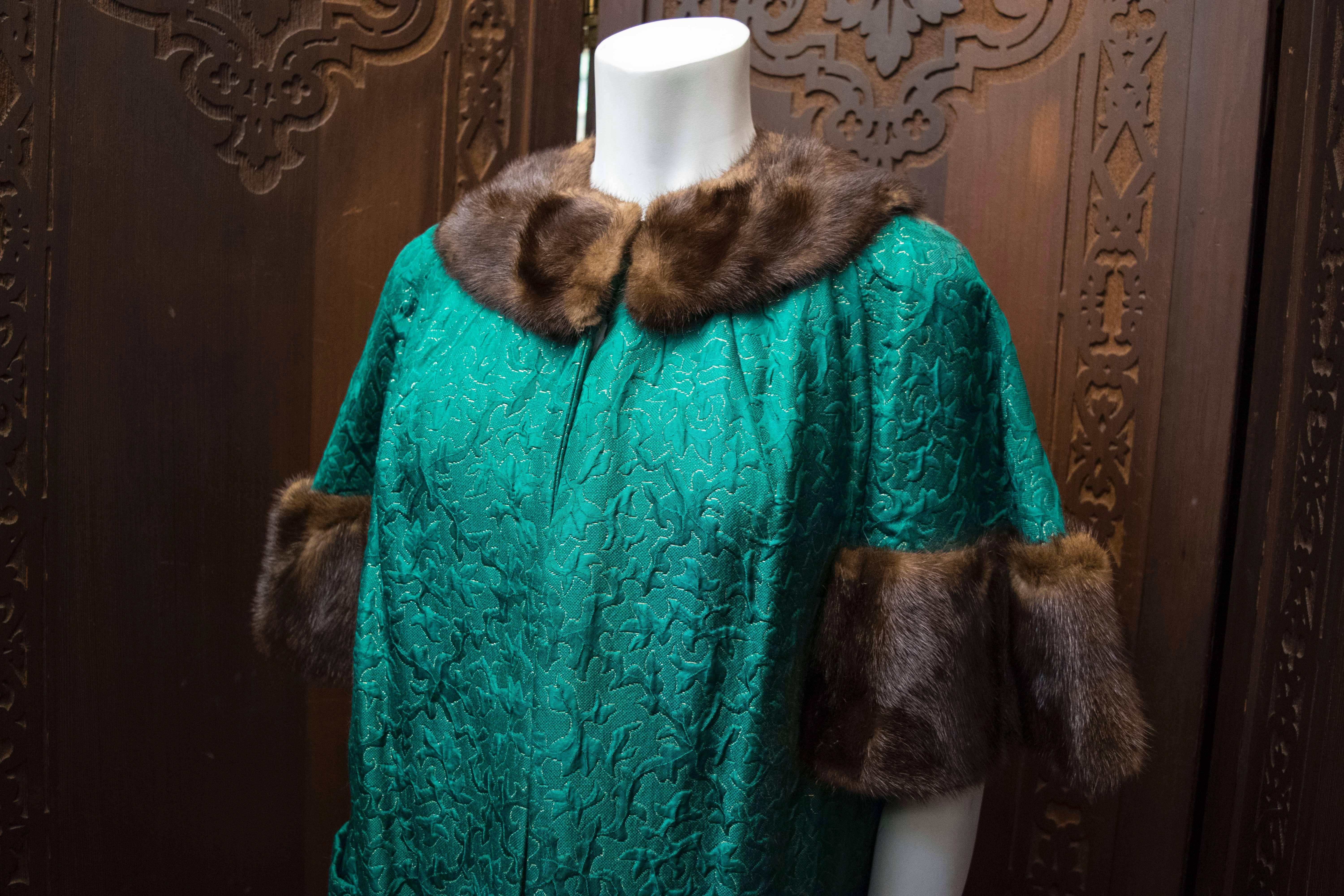 1960s Green Brocade Dress and Coat.

Incredible late 1950s, early 1960s era dress and opera coat! Shimmery green brocade with gold lamé thread and nice wide-cut half length sleeves with mink trim. Lined in green silk. Natural mink fur collar and