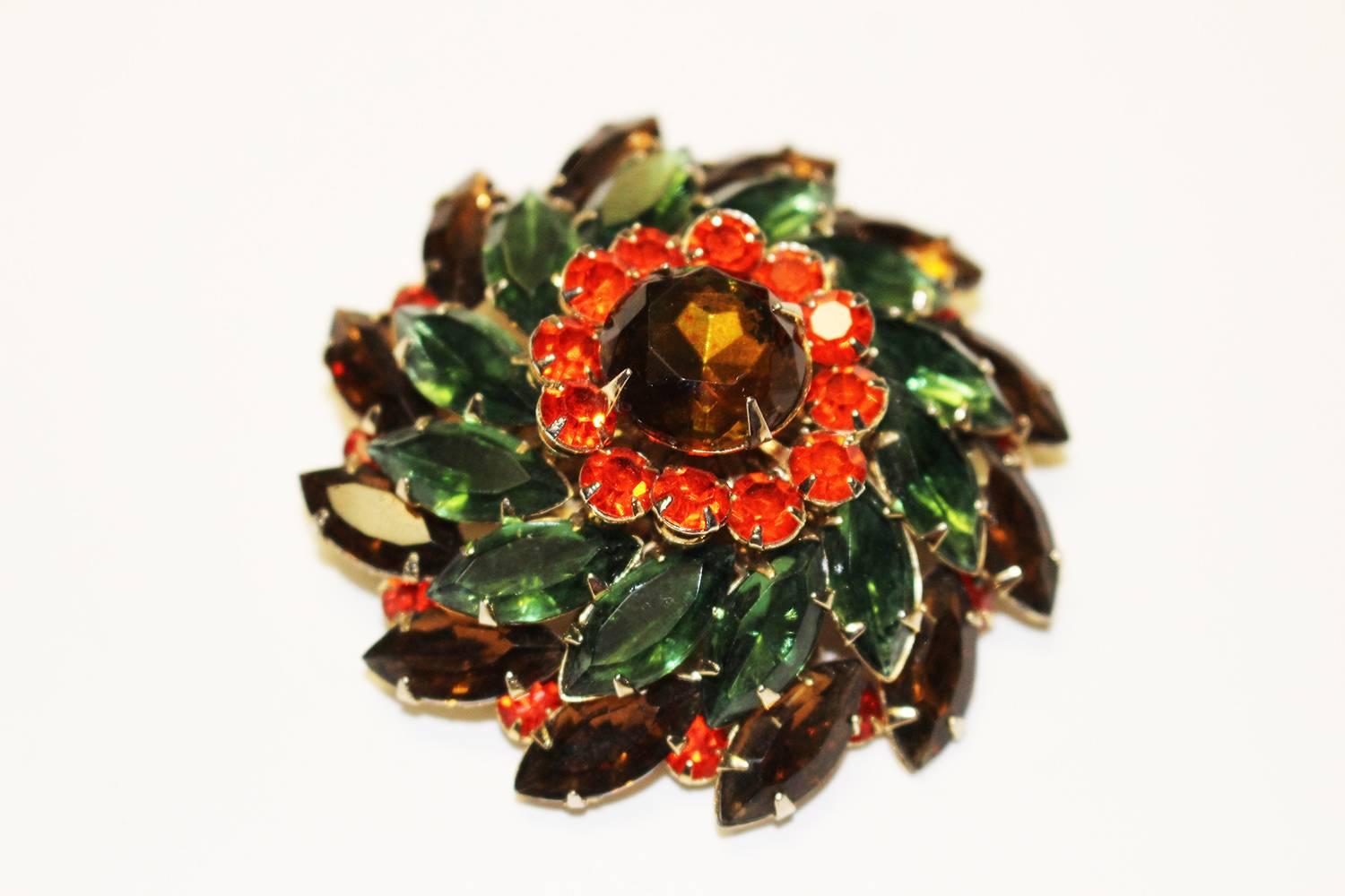 1960's earring and brooch set with green, brown, and flame orange rhinestones arranged in a starburst pattern by designer Judy Lee. Earrings are clip-on. This classic vintage brooch and earring set will compliment your ensemble! 