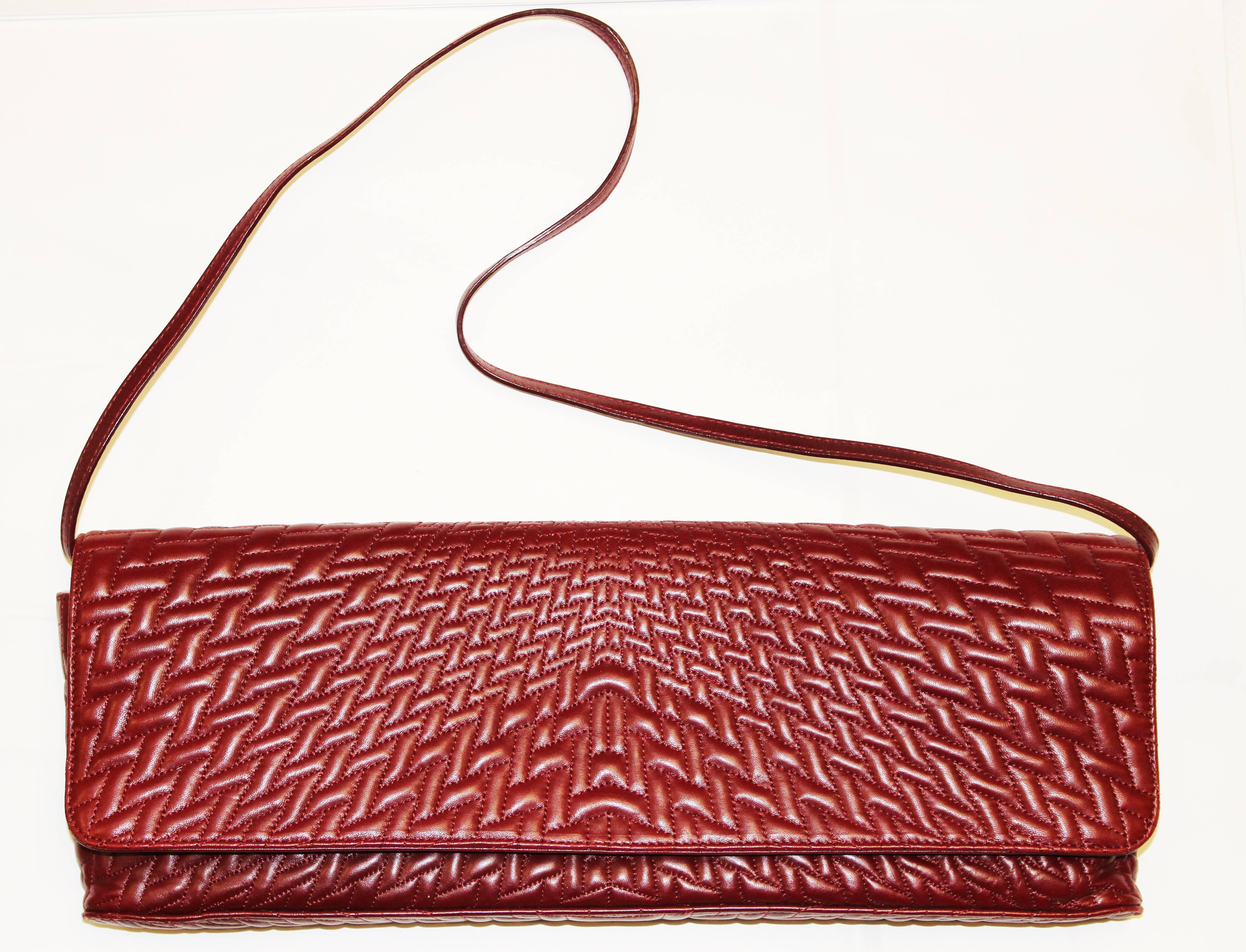 1990's quilted buttery-soft napa leather Giorgio Armani convertible purse. Amazing all-over symmetrical quilting with magnetic closure. Strap can be tucked into bag to transform it into a clutch. Pristine suede lining. Inner zip pocket.