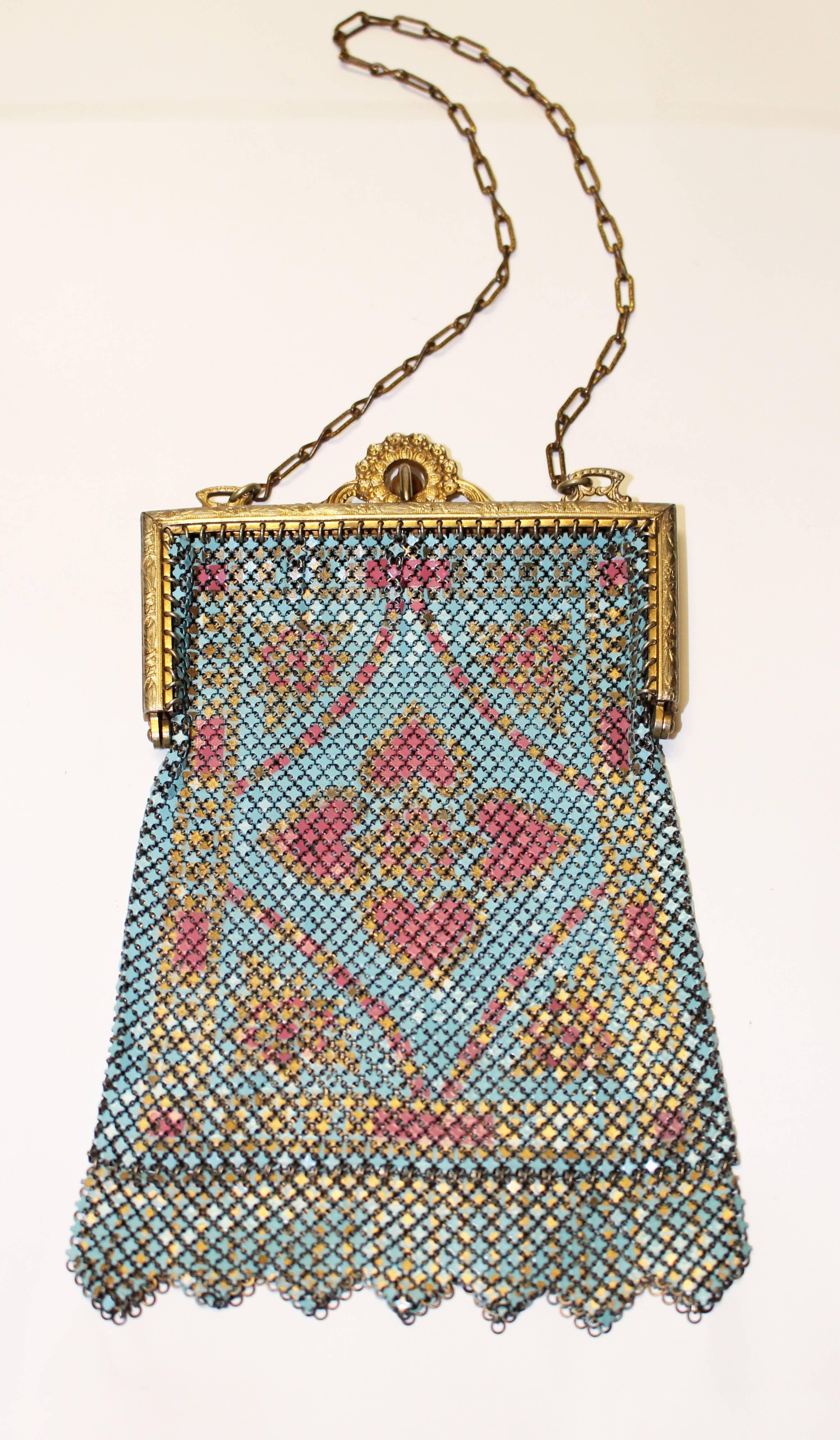 1920's painted bright blue and pink mesh purse with floral design. Zigzag mesh panel fringe and ornate gold tone frame. Elegant metal chain handle.

Measurements:
Handle: 12" long
Length: 6" long including mesh fringe
Width: 4"
