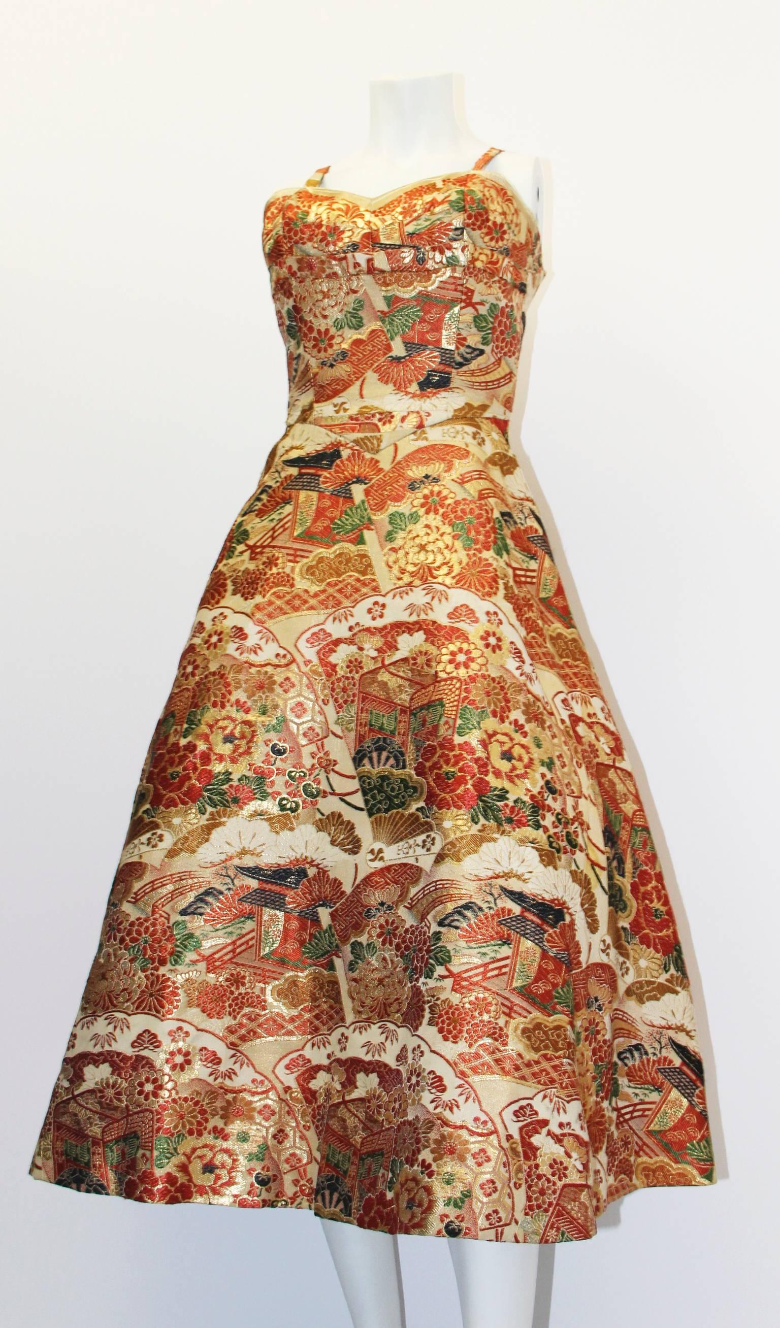 Stunning 1950's Kimono fabric tapestry weight cocktail dress with gold lamé threading throughout. Unusual chinoiserie subject matter. Heavyweight fabric is beautifully constructed into the classic 1950's silhouette with nipped waist, fitted bodice
