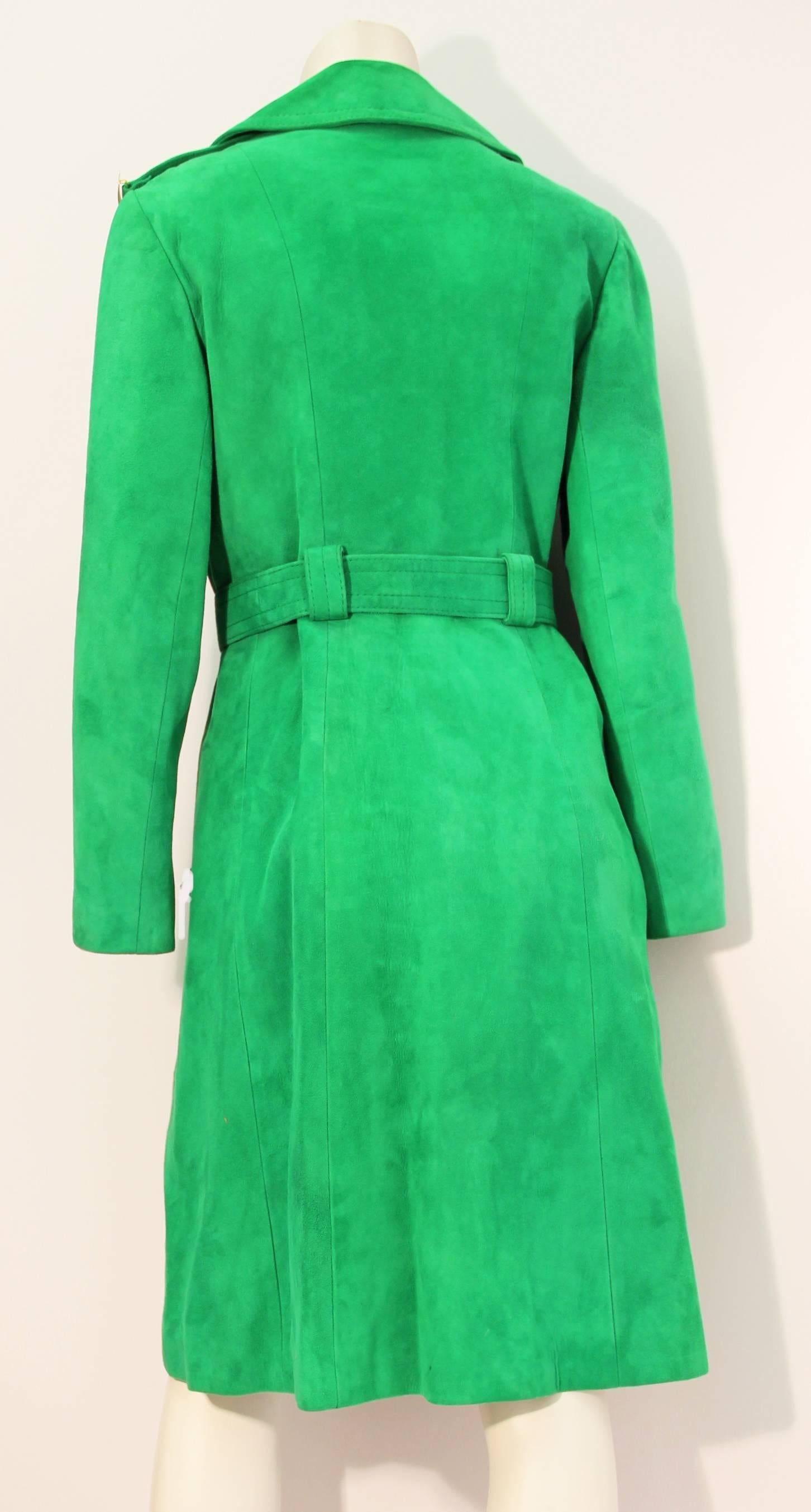 Exceptional 1970's green suede trench coat. Original brass buttons, hardware on shoulder epaulets and buckle. This is what Emma Peel would have worn in the hit British television series The Avengers. Absolutely Fabulous! 

Size: Approximately a