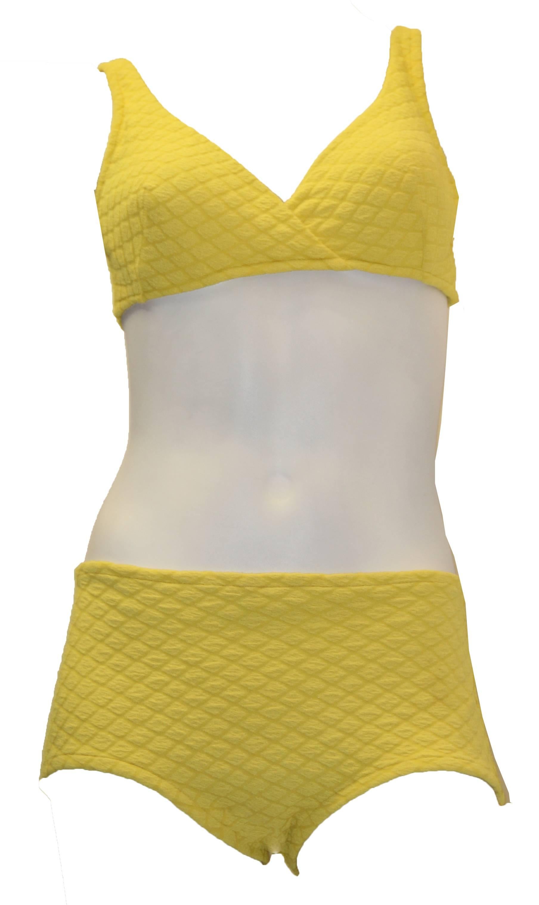 1960s Rose Marie Reid yellow textured two piece bathing suit. Cross over top with single hook back closure. Sculpted bra cups lined in durable synthetic lace. Fabric is in great wearable condition with stretch still available.