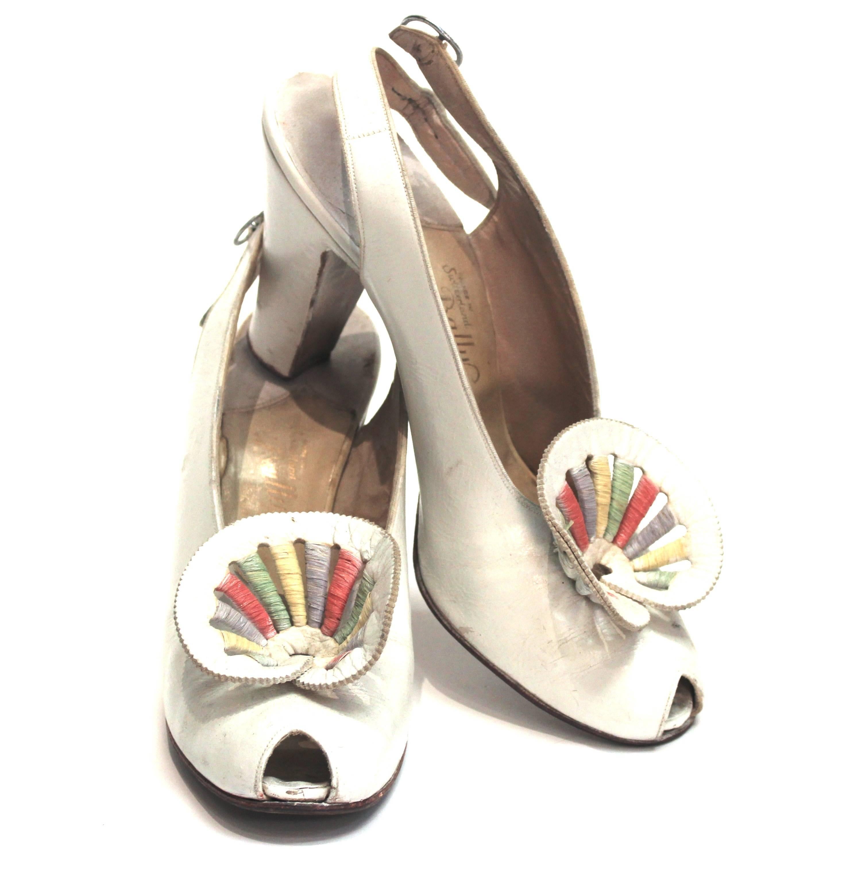 30s slingback peep-toe heels. Colorful rosette toe adornments. Leather upper and sole, wood heels. 

Measurements: 
Insole: 9 1/2