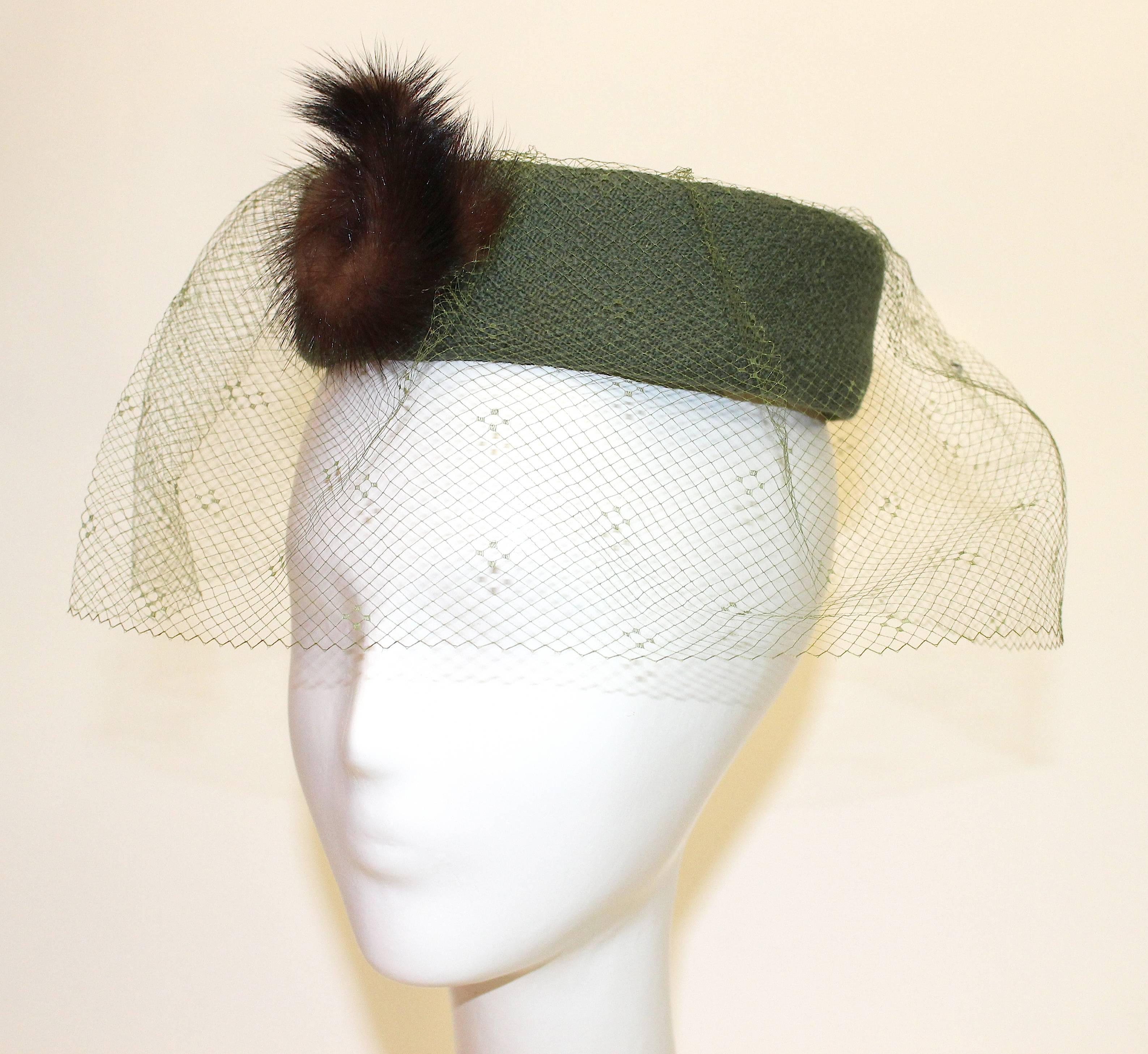 1950s Jack Mann Dress and Matching Hat Both with Mink Fur Accents. Two tone heathered sage green wool gaberdine.   Mink buttons. Matching pillbox hat with veil and mink embellishment. 

Measurements:
Dress
Bust: 34