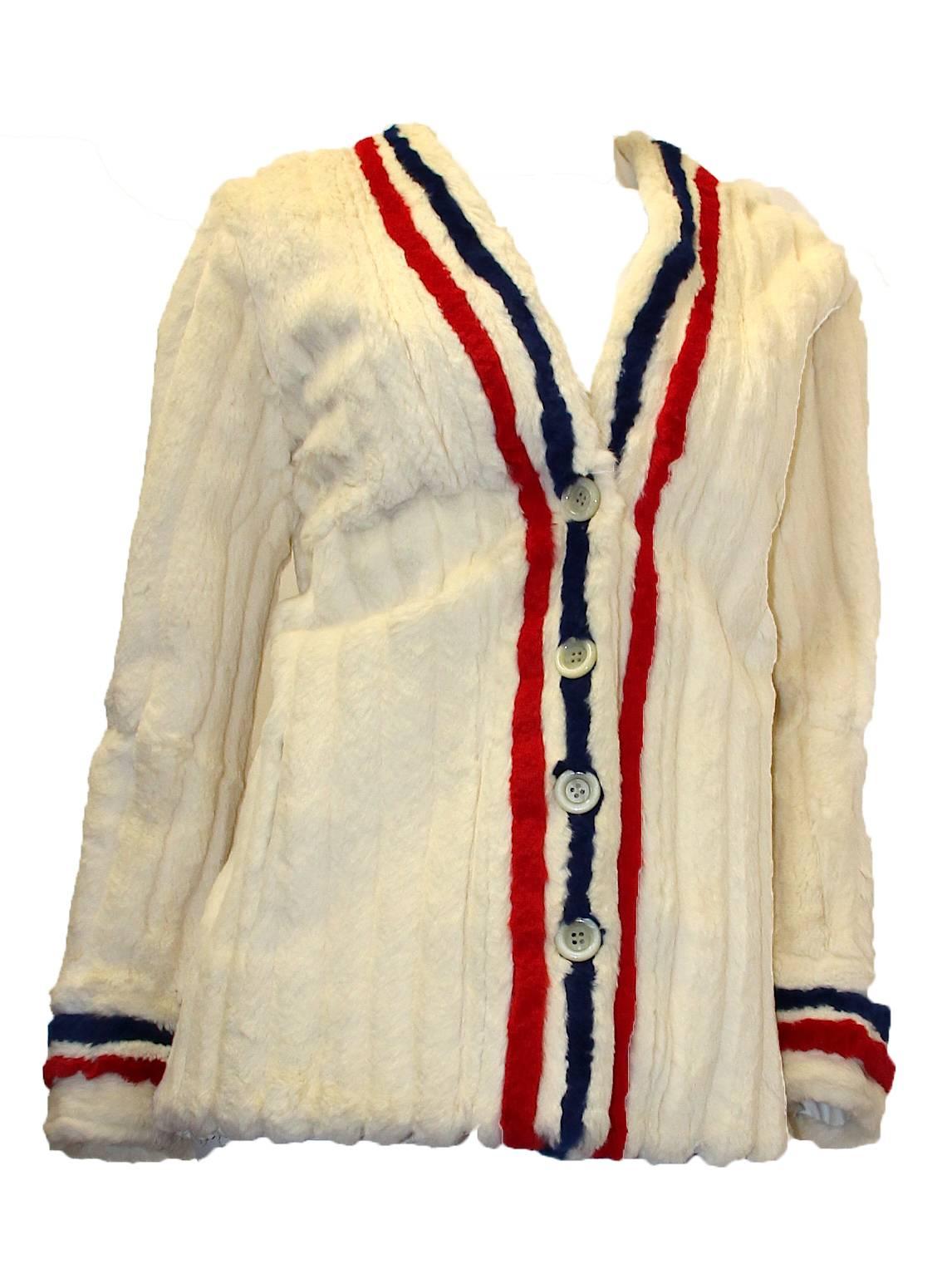 1960s I.Magnin tricolor ermine fur jacket. Red, white, and blue trim on cuffs and center front. Center front button closure. Two in-seam pockets at front. 

Measurements:
Bust: 37