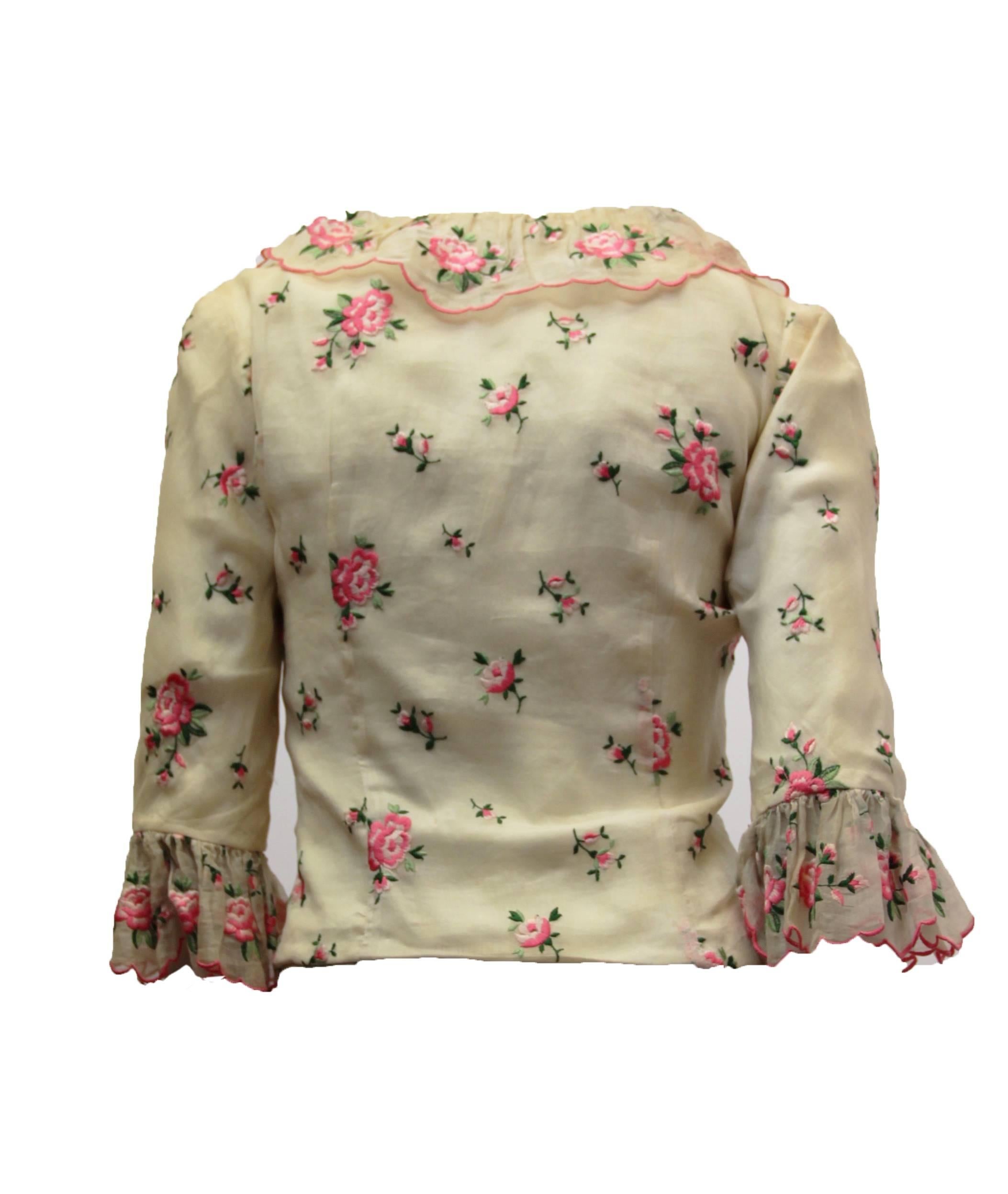 50s Castillo rose embroidered top with ruffle collar and cuffs. Organdy overlay on crepe de chine. Cut out waist line. Snaps up the front. Made in France for I. Magnin  