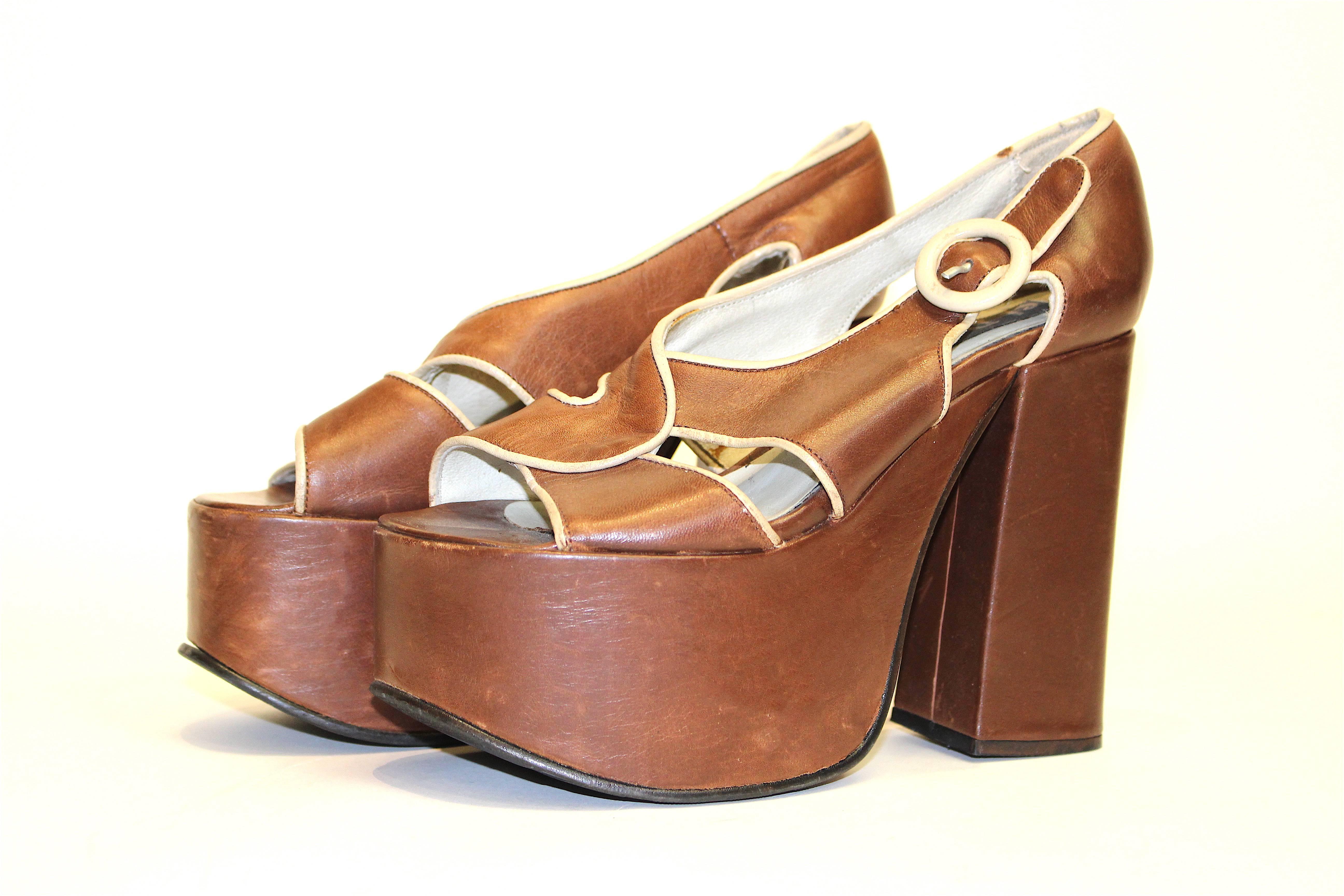 El Dantes 70s Platform shoe Brown leather with cream colored piping and buckle. Slip-on shoes w/ faux buckle closure. Some wear on leather, namely on the buckle.

US size 6 with an approximately 3 inch width