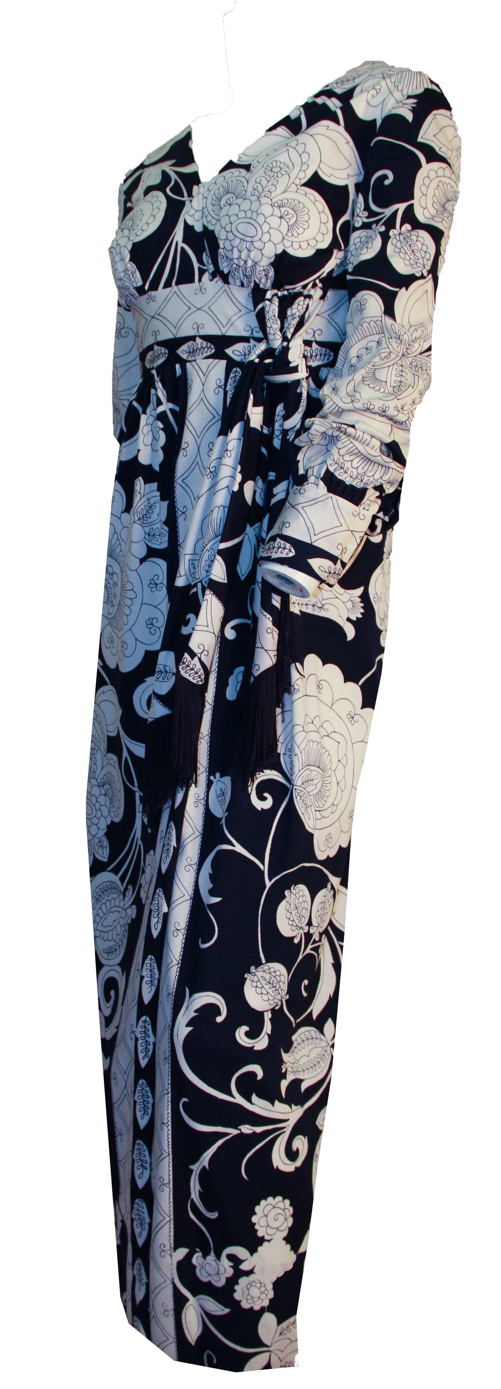 70s navy & white fantasy print long sleeve column dress. Empire waist faux sash tie trimmed in navy fringe. Nylon zipper. 

