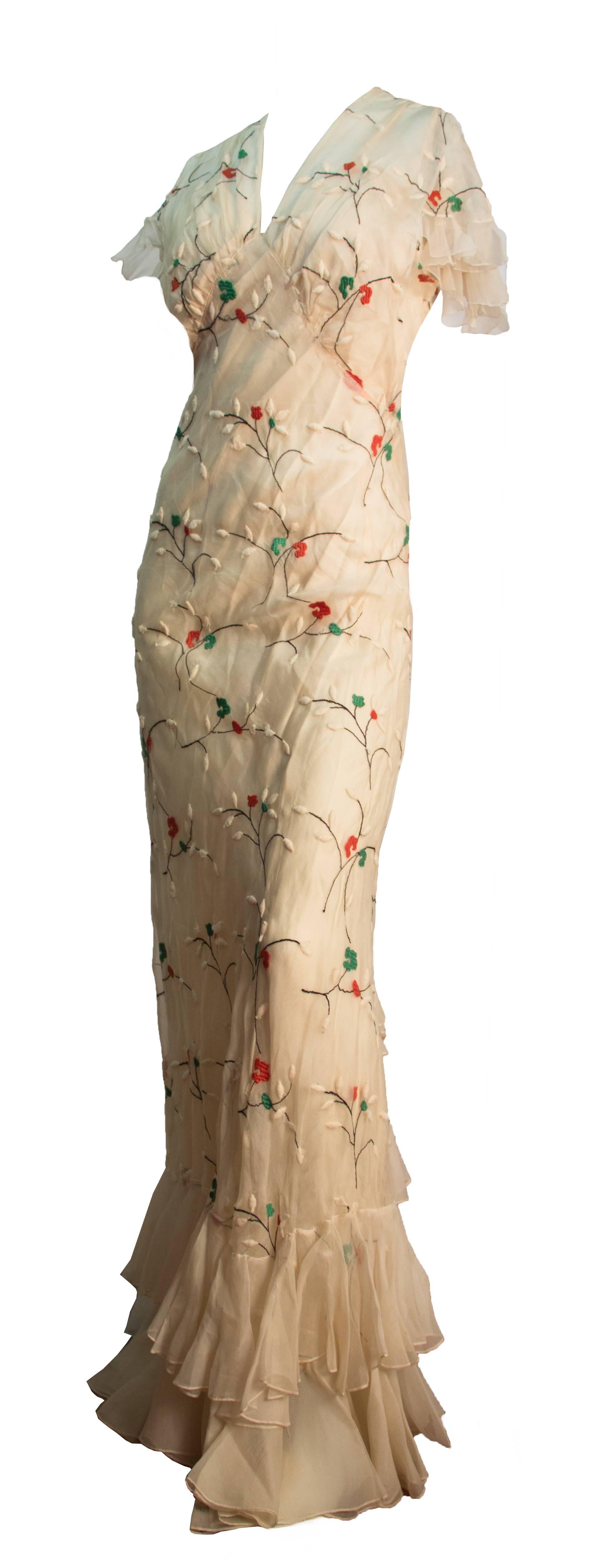 30s cream colored bias cut sheer silk dress with ruffle hem, trim and flutter sleeves. Floral embroidery. Original bias cut slip.

 